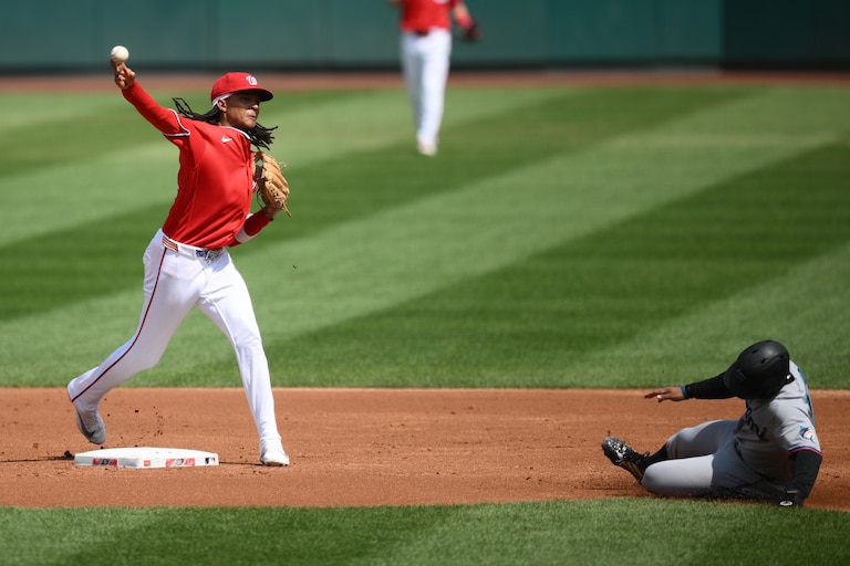 Miami Marlins' Xavier Edwards, right, is out at second base as Washington Nationals second baseman CJ Abrams, left, throws to first base to put out Marlins' Javier Sanoja for a double-play during the second inning of a baseball game, Sunday, Aug. 30, 2026, in Washington. (AP Photo/Nick Wass)