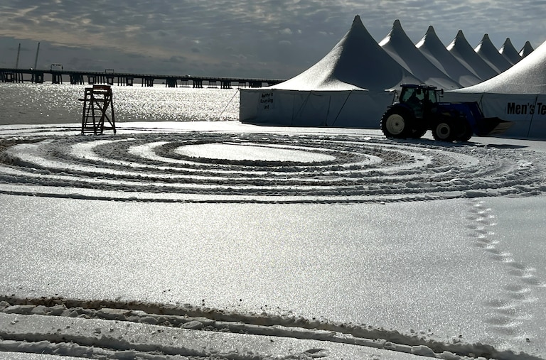 A tractor on Monday drives on the beach at Sandy Point State Park while plowing and preparing for the Maryland Polar Bear Plunge.