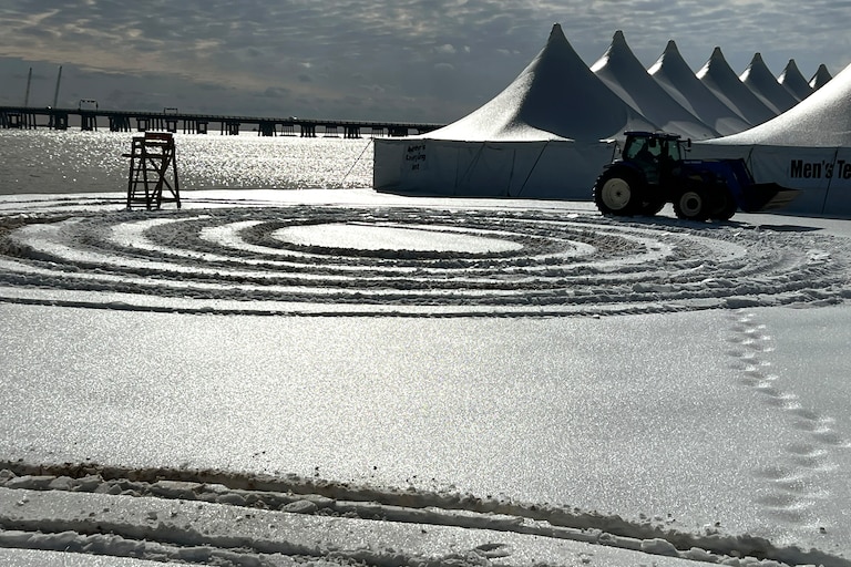 A tractor on Monday drives on the beach at Sandy Point State Park while plowing and preparing for the Maryland Polar Bear Plunge.