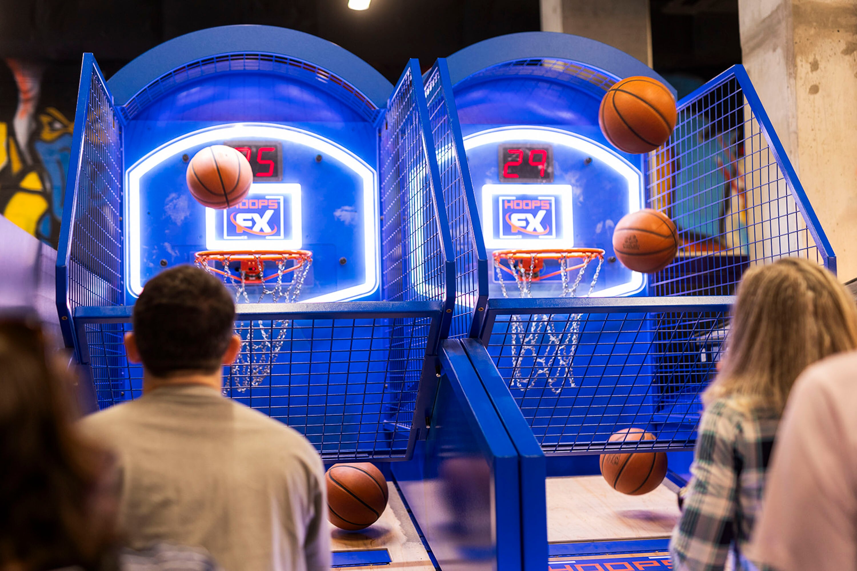 Young professionals shoot baskets at a networking event at GameOn Bar + Arcade in Columbia on Aug. 22, 2024.