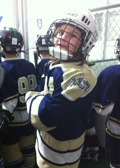 Lacey Eden waits with teammates in the bench area during her youth hockey days with the Navy Youth Hockey Association. Often the only girl on the ice, Eden competed against boys throughout much of her development before moving to the Shattuck-St. Mary’s School.