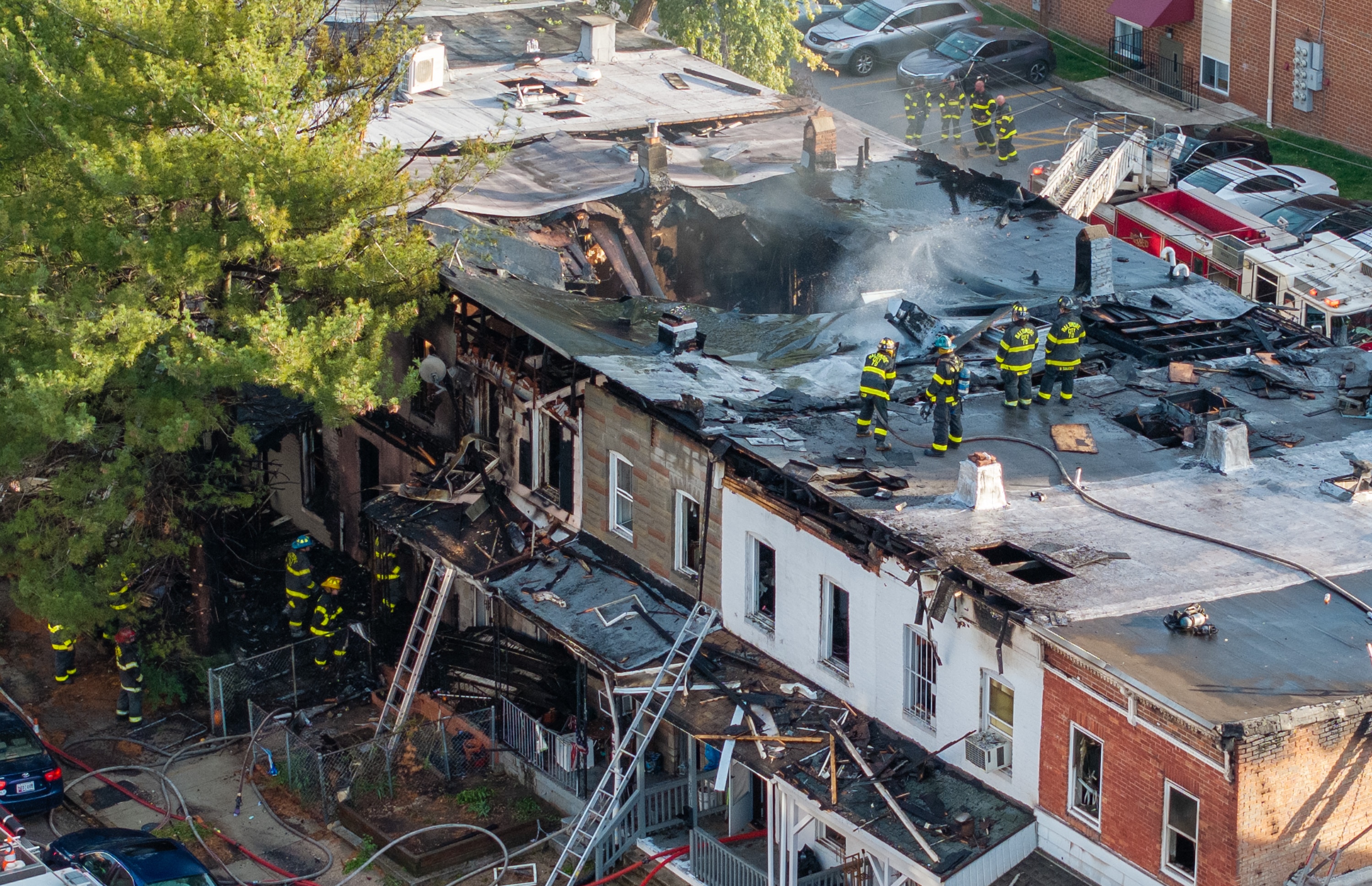 Baltimore City firefighters mop up a five-alarm fire on the 3400 block of Keswick Road Tuesday morning.