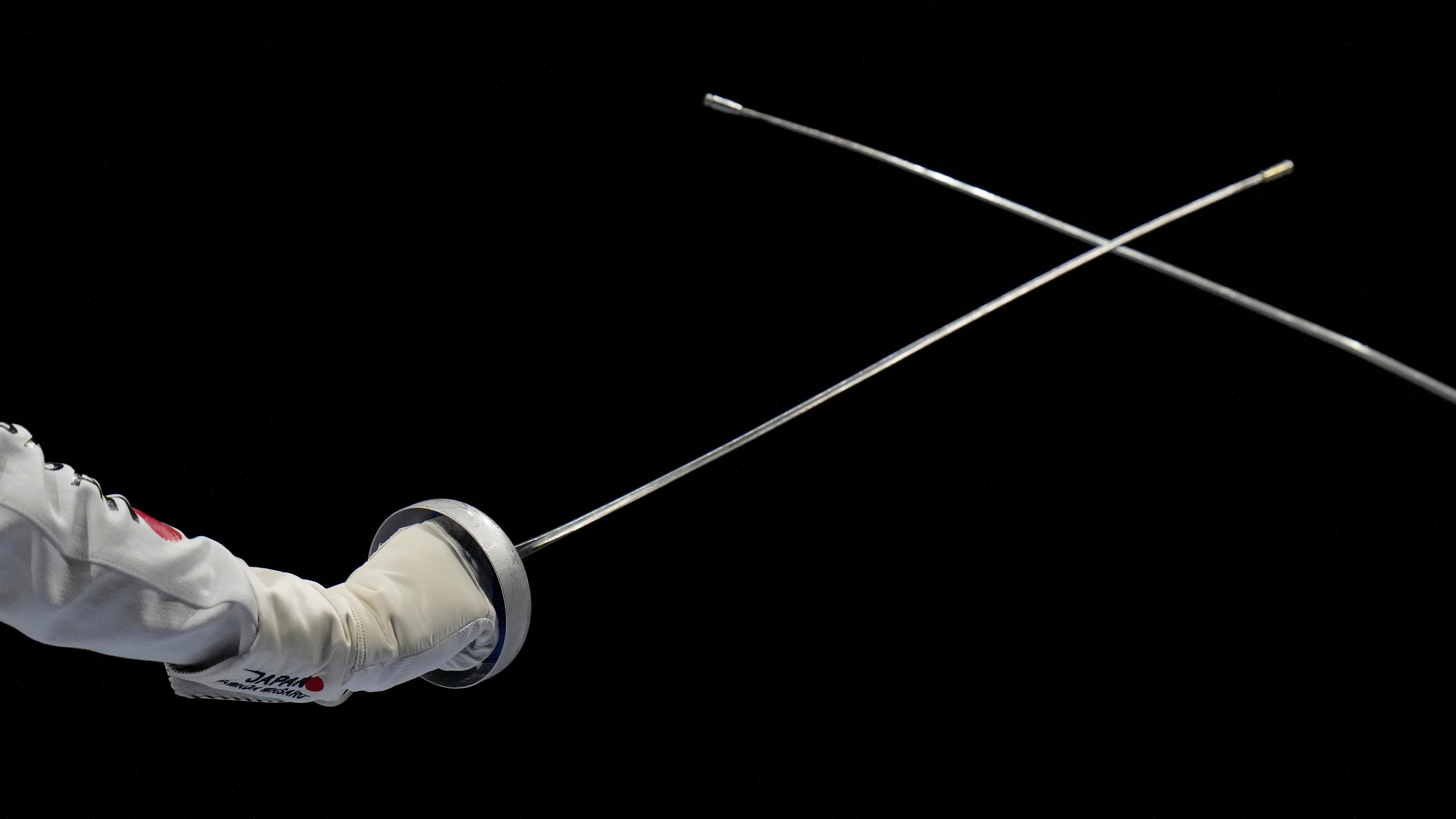 Masaru Yamada of Japan, left, and Yeisser Ramirez of the United States compete in the men's individual Epee team round of 16 competition at the 2020 Summer Olympics, Friday, July 30, 2021, in Chiba, Japan. (AP Photo/Hassan Ammar)