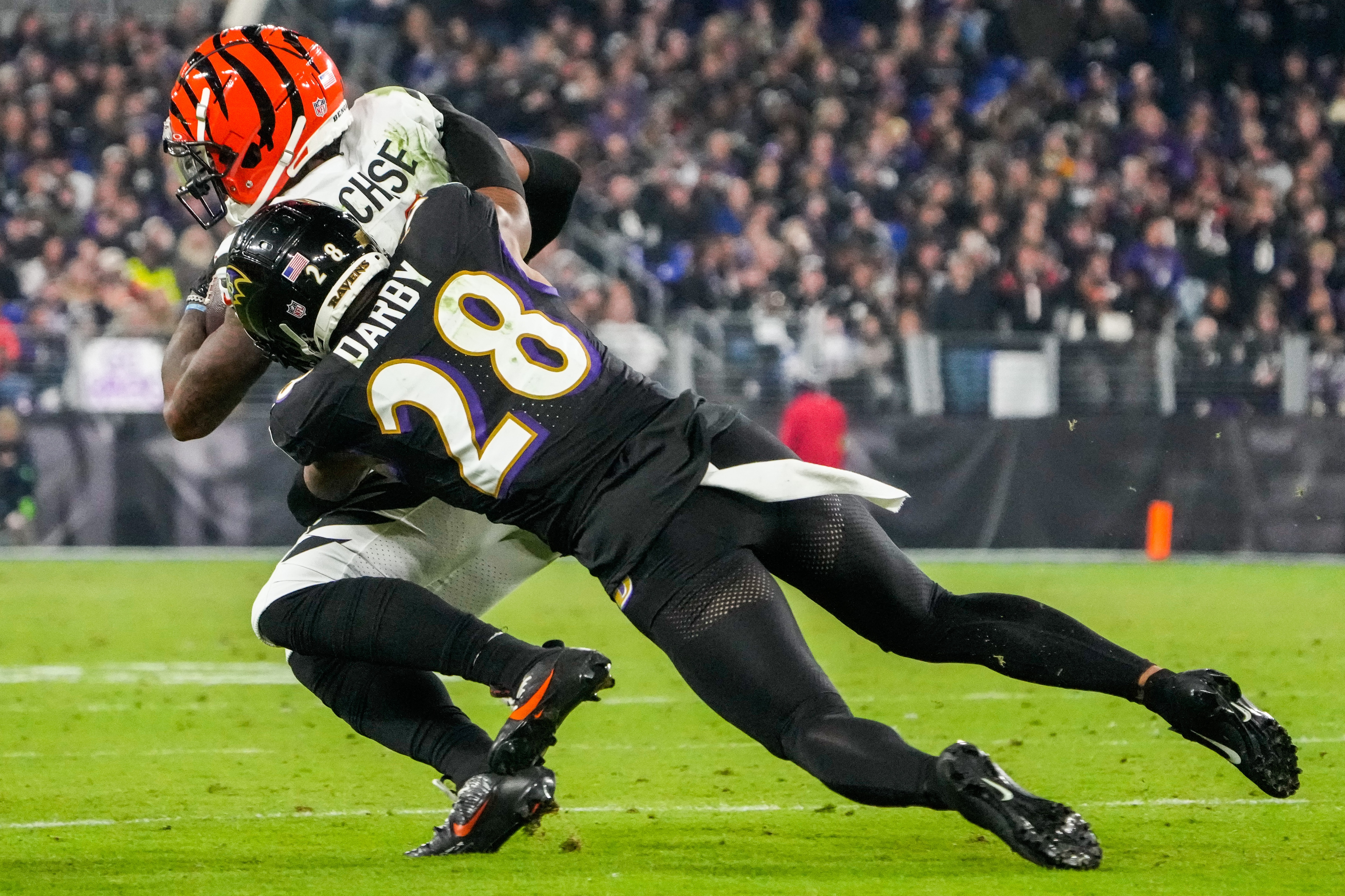 Baltimore Ravens cornerback Ronald Darby (28) tackles Cincinnati Bengals wide receiver Ja’Marr Chase (1) during the third quarter at M&T Bank Stadium on Thursday, Nov. 16, 2023.