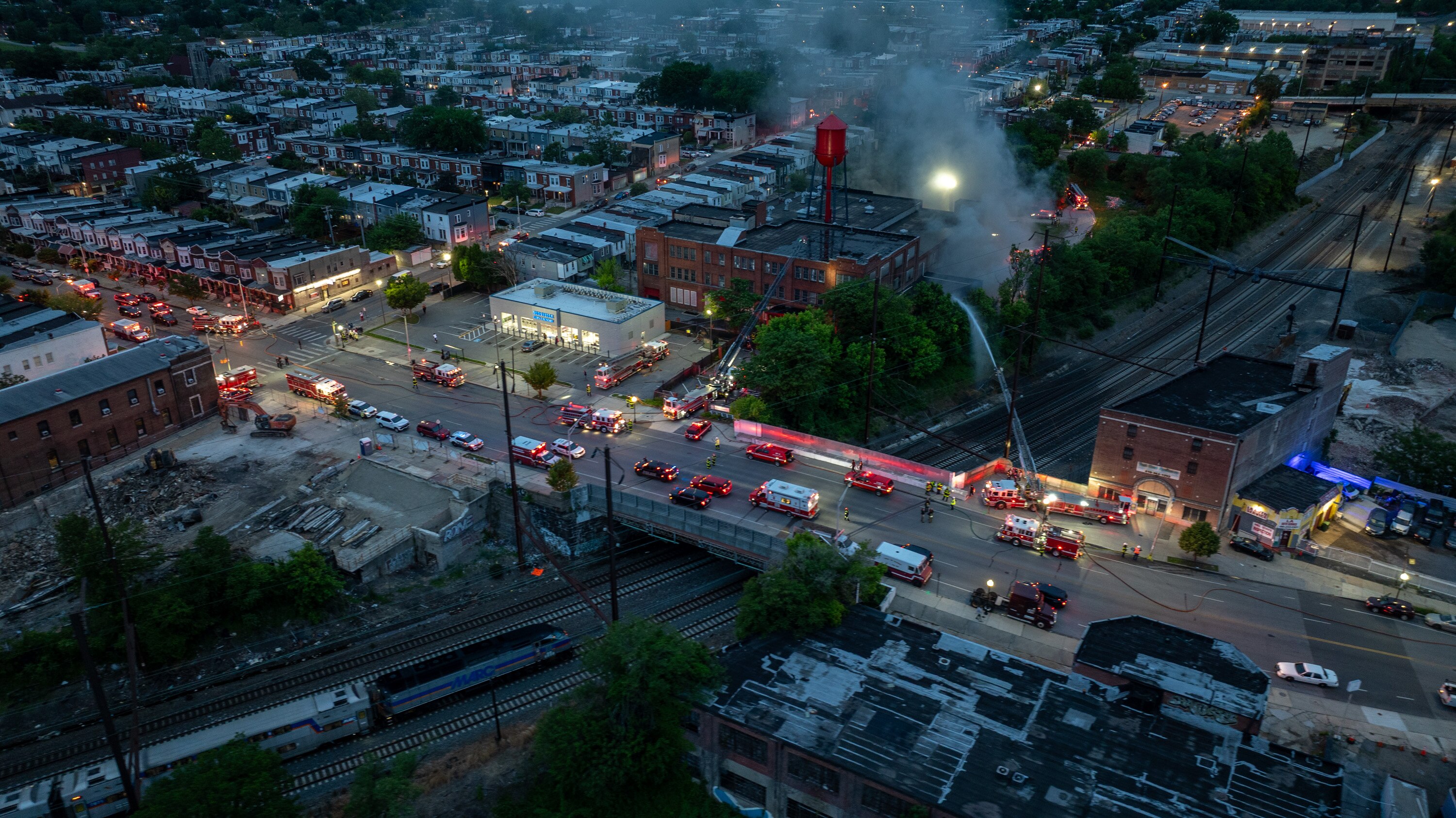 Fire officials said a blaze in West Baltimore, which peaked at a seven-alarm incident late Monday, is contained as of Tuesday night.