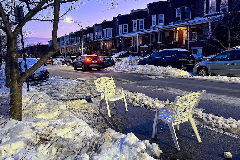 Residents use chairs to mark a shoveled-out parking space in the Charles Village neighborhood of Baltimore on Wednesday.