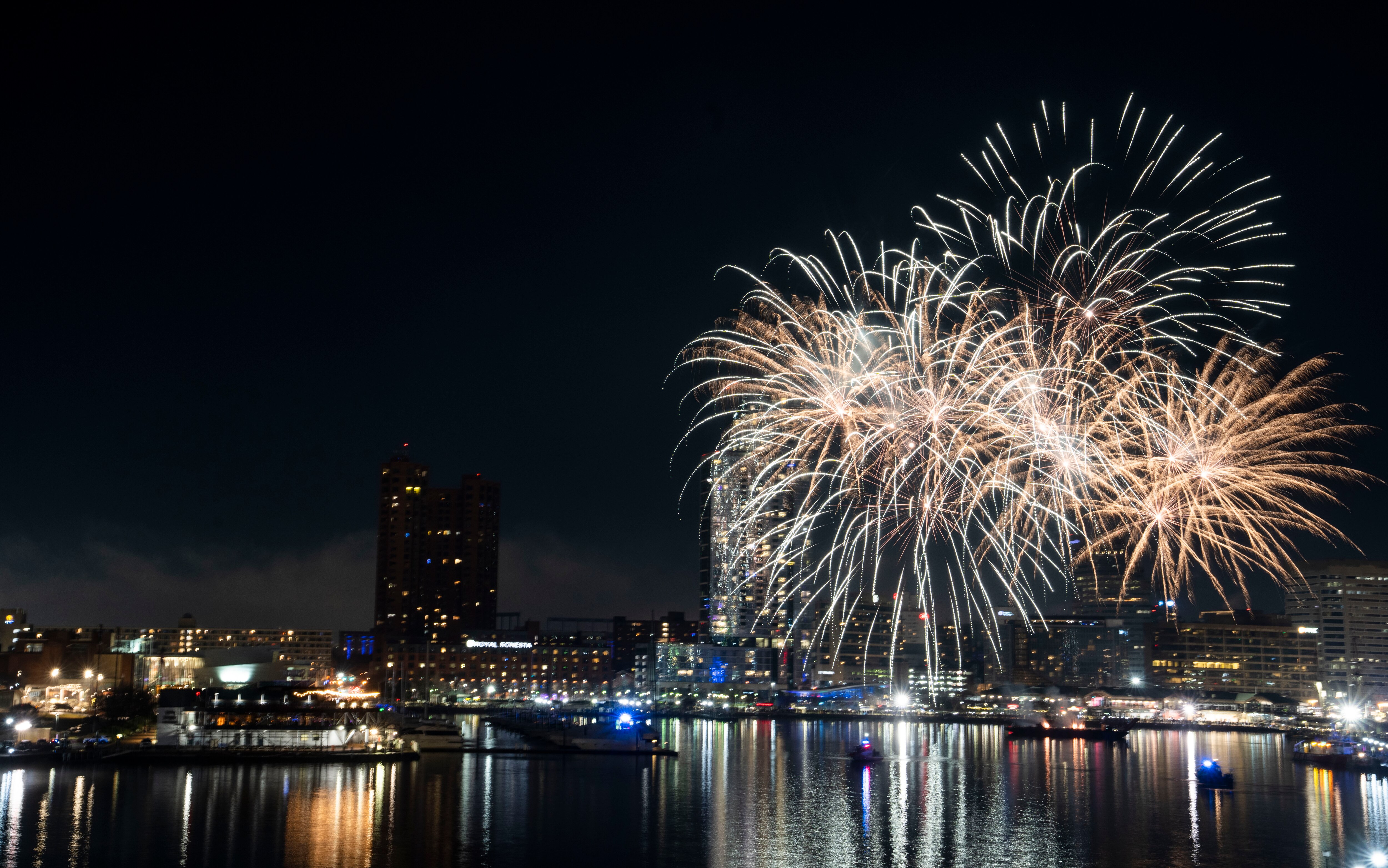 Fireworks shoot off into the sky to celebrate the New Year, seen from the fourth-floor terrace of the Four Seasons Hotel Baltimore, Sunday, January 1, 2023.