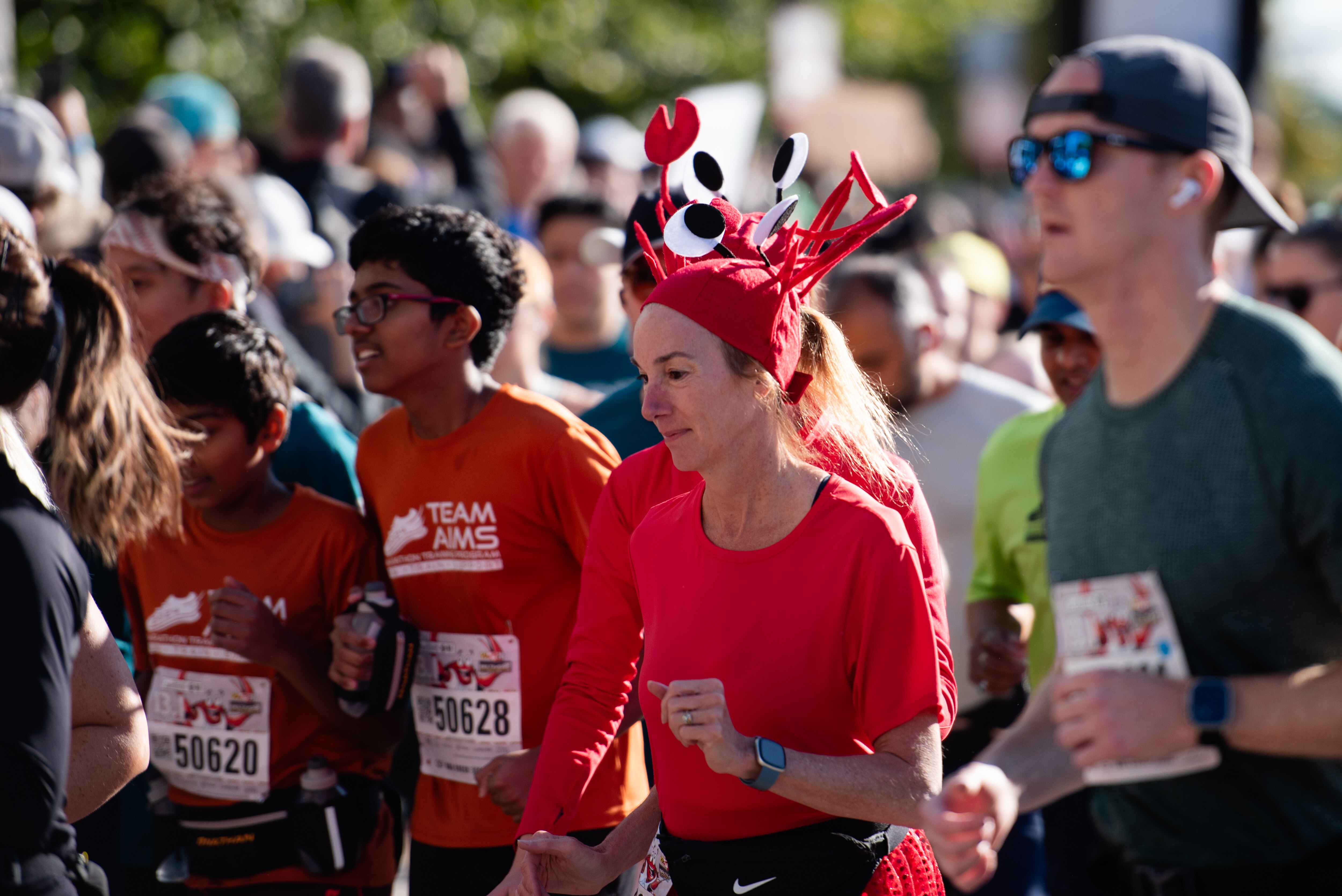 A Half Marathon runner sports a crab hat during the Baltimore Running Festival on October 19th, 2024 in Baltimore, MD. Eric Thompson for The Baltimore Banner.