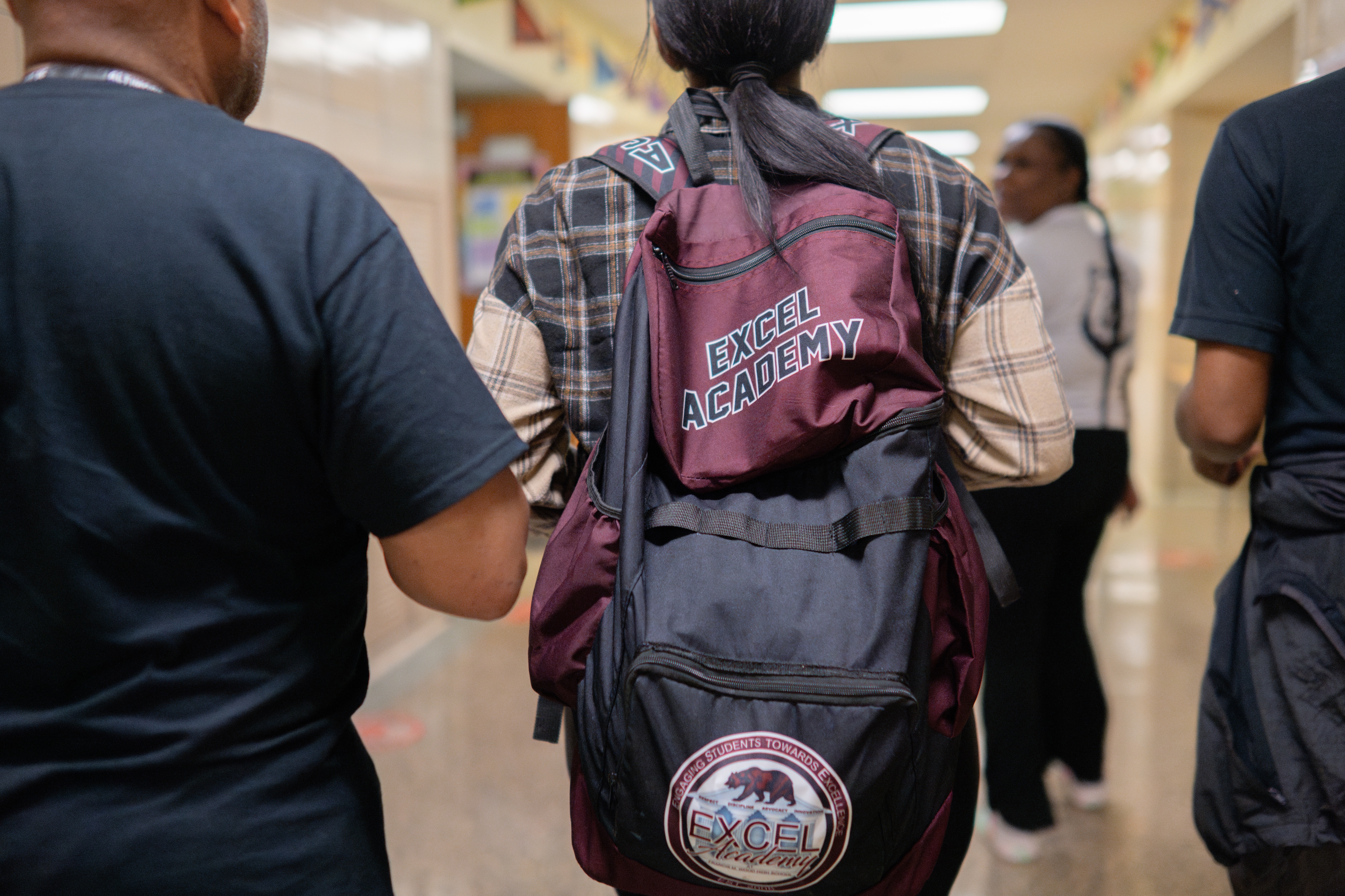 Staff and students walk through the hallways of the Excel Academy at Francis M. Wood High School, where efforts to boost attendance have received mayoral recognition.