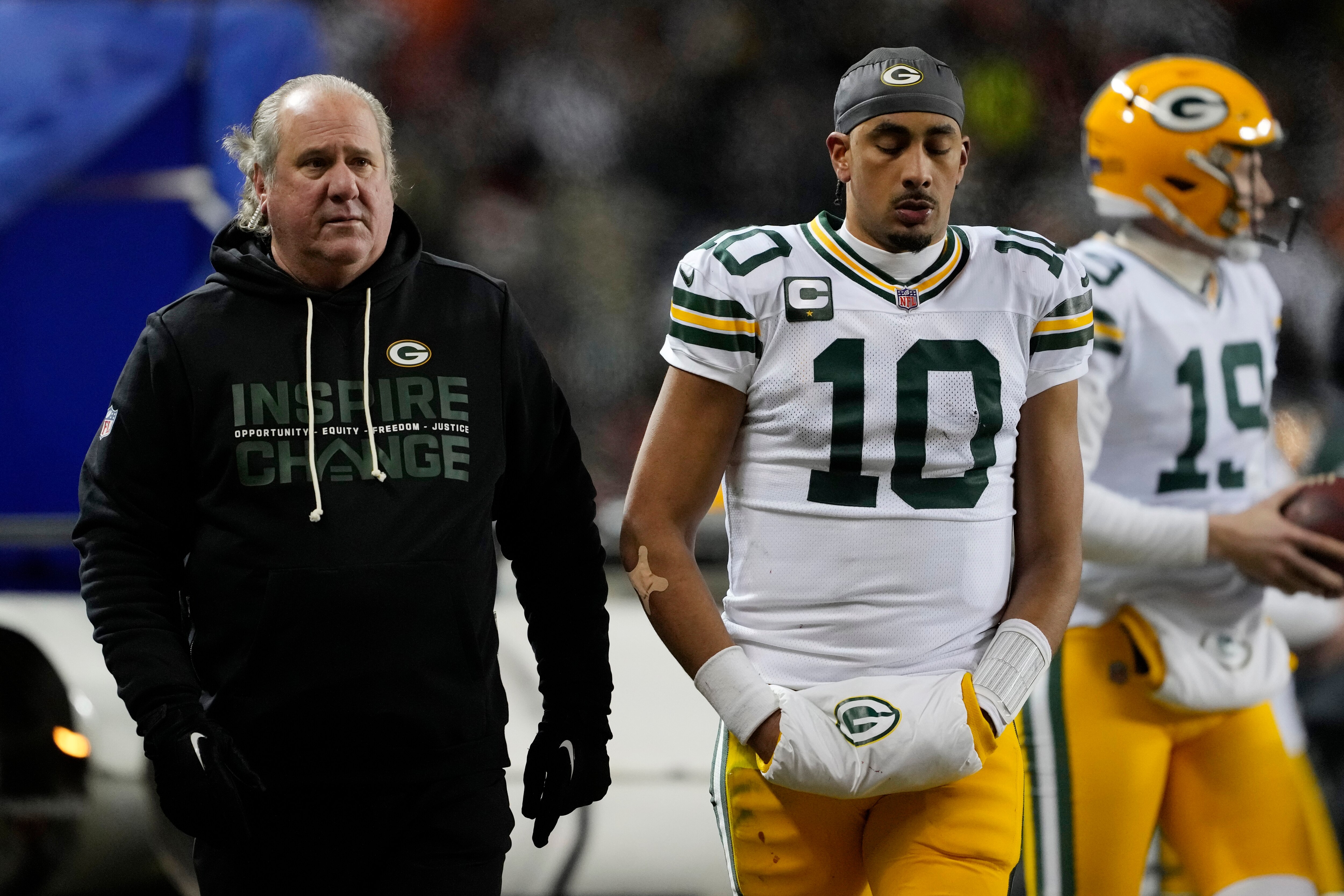 Packers quarterback Jordan Love leaves the field after he suffered a concussion Saturday night in Chicago.