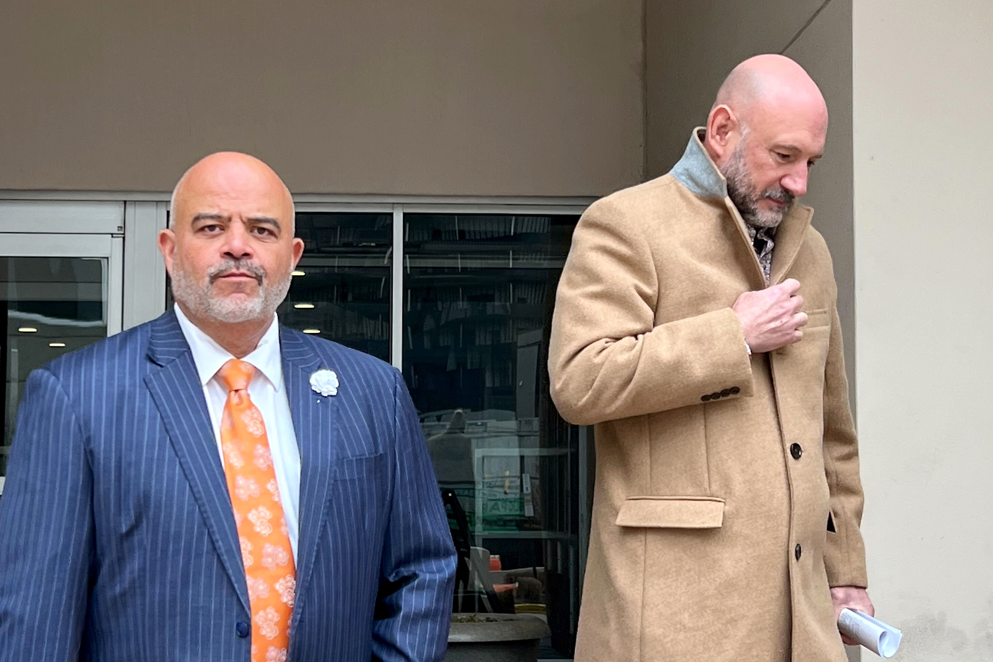 James Carroll Erny Jr., right, leaves the U.S. District Court in Baltimore on Thursday, joined by his attorney, Tony Garcia.