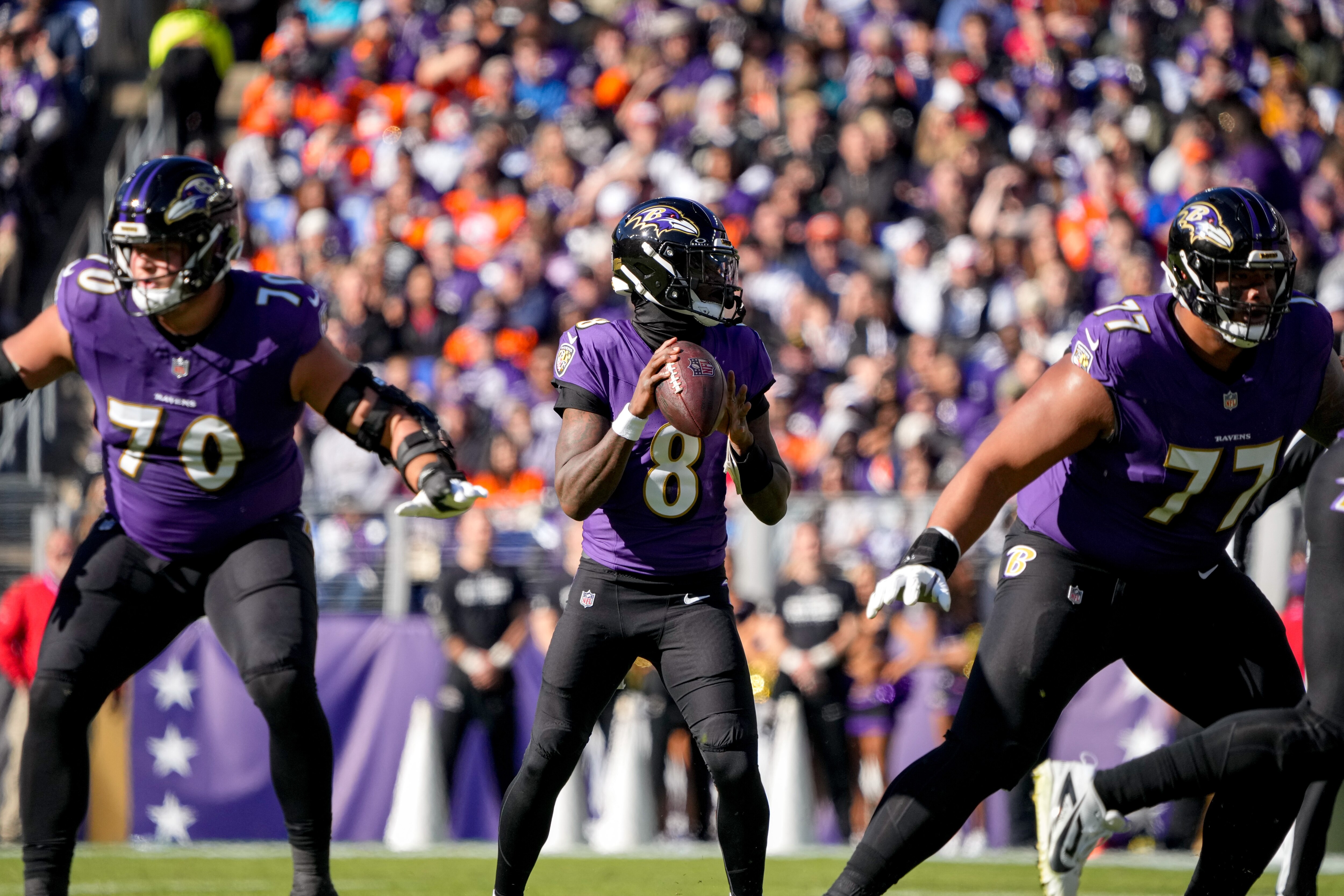 Rookie offensive tackle Roger Rosengarten helps to protect quarterback Lamar Jackson in the pocket.