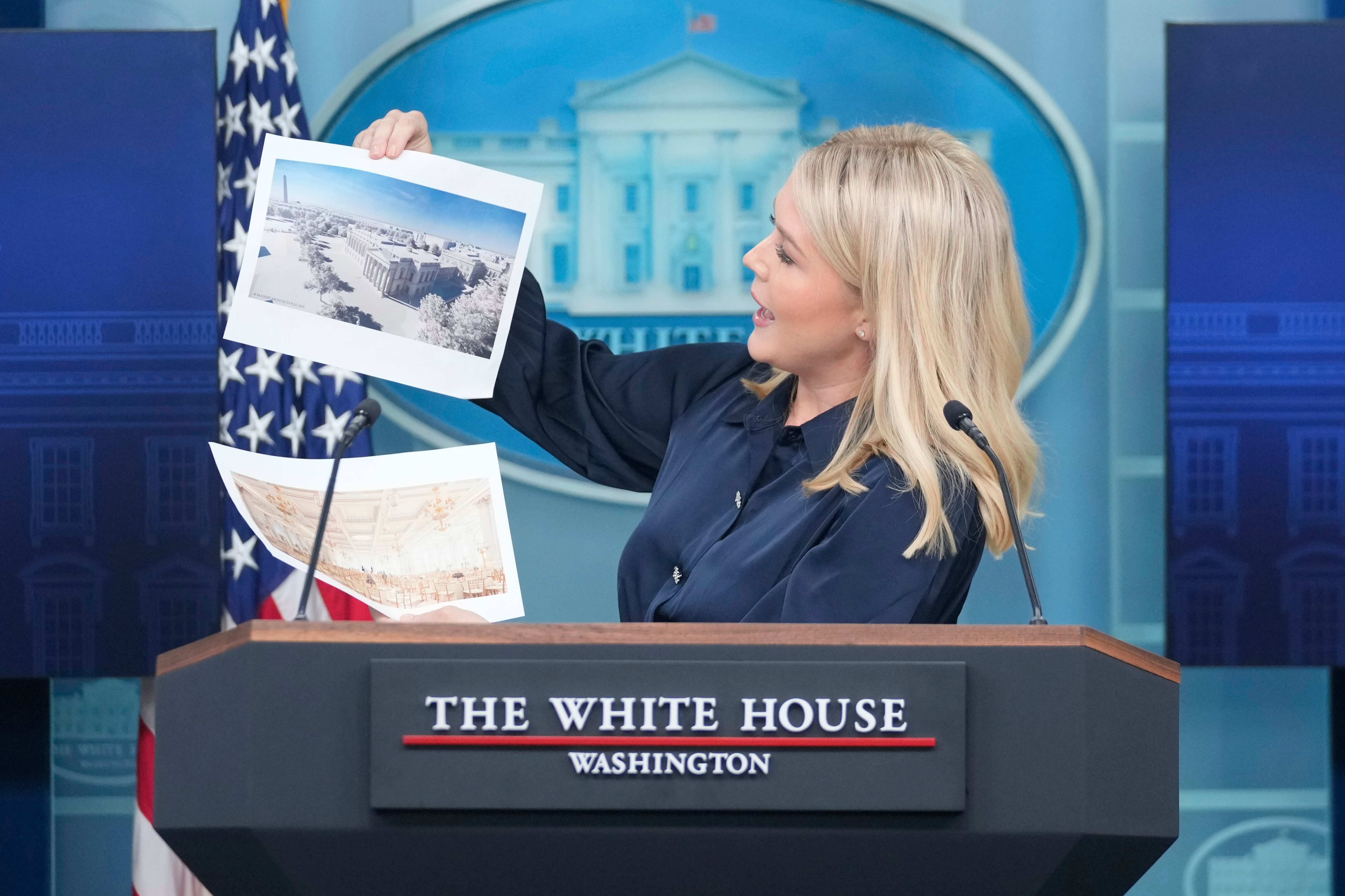 White House press secretary Karoline Leavitt holds up photos of the planned new White House ballroom during a press briefing at the White House in Washington, Thursday, July 31, 2025.
