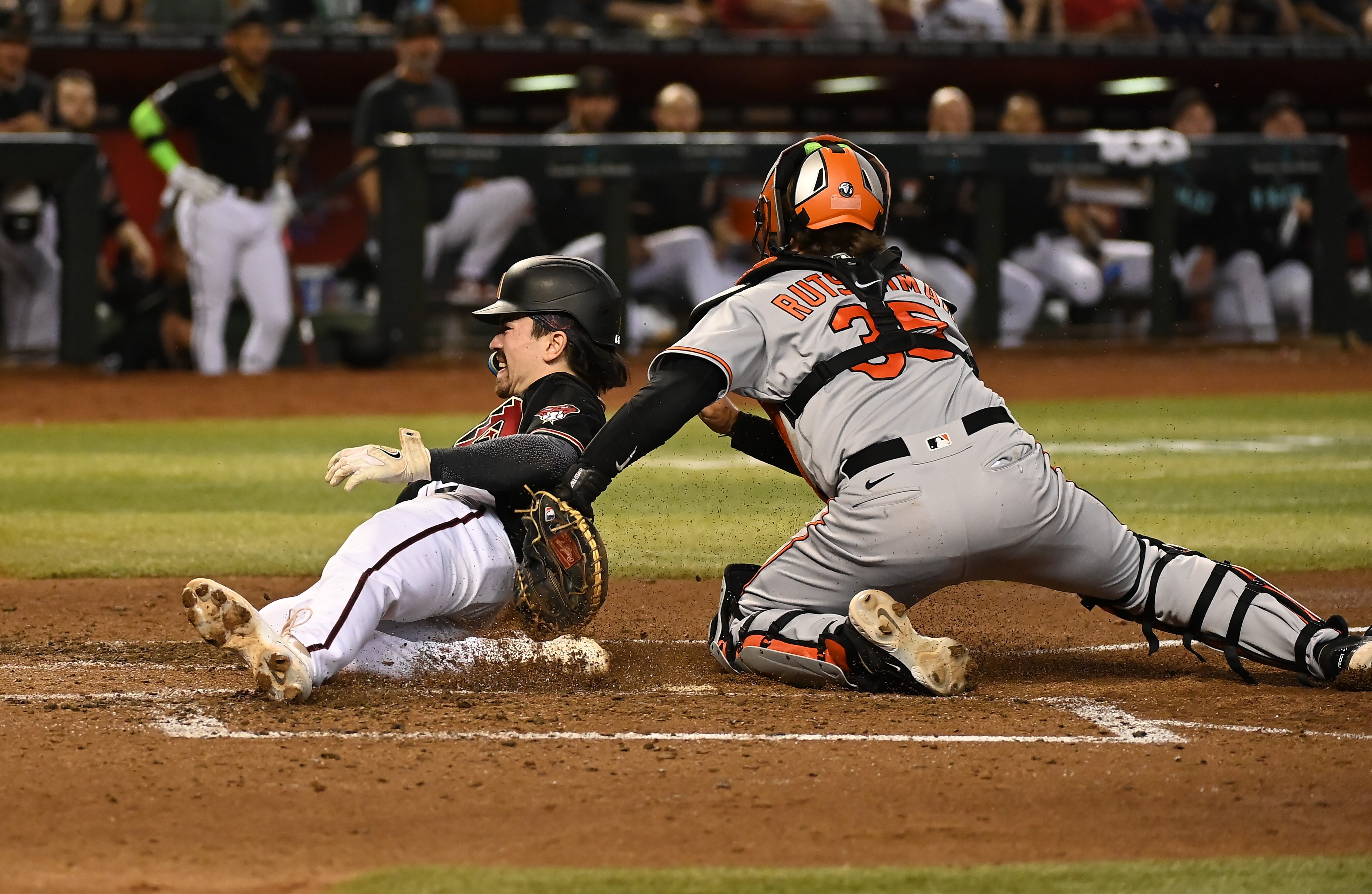 Orioles catcher Adley Rutschman tags out Arizona's Corbin Carroll to complete the double play started by Gunnar Henderson in the fourth inning Friday night.