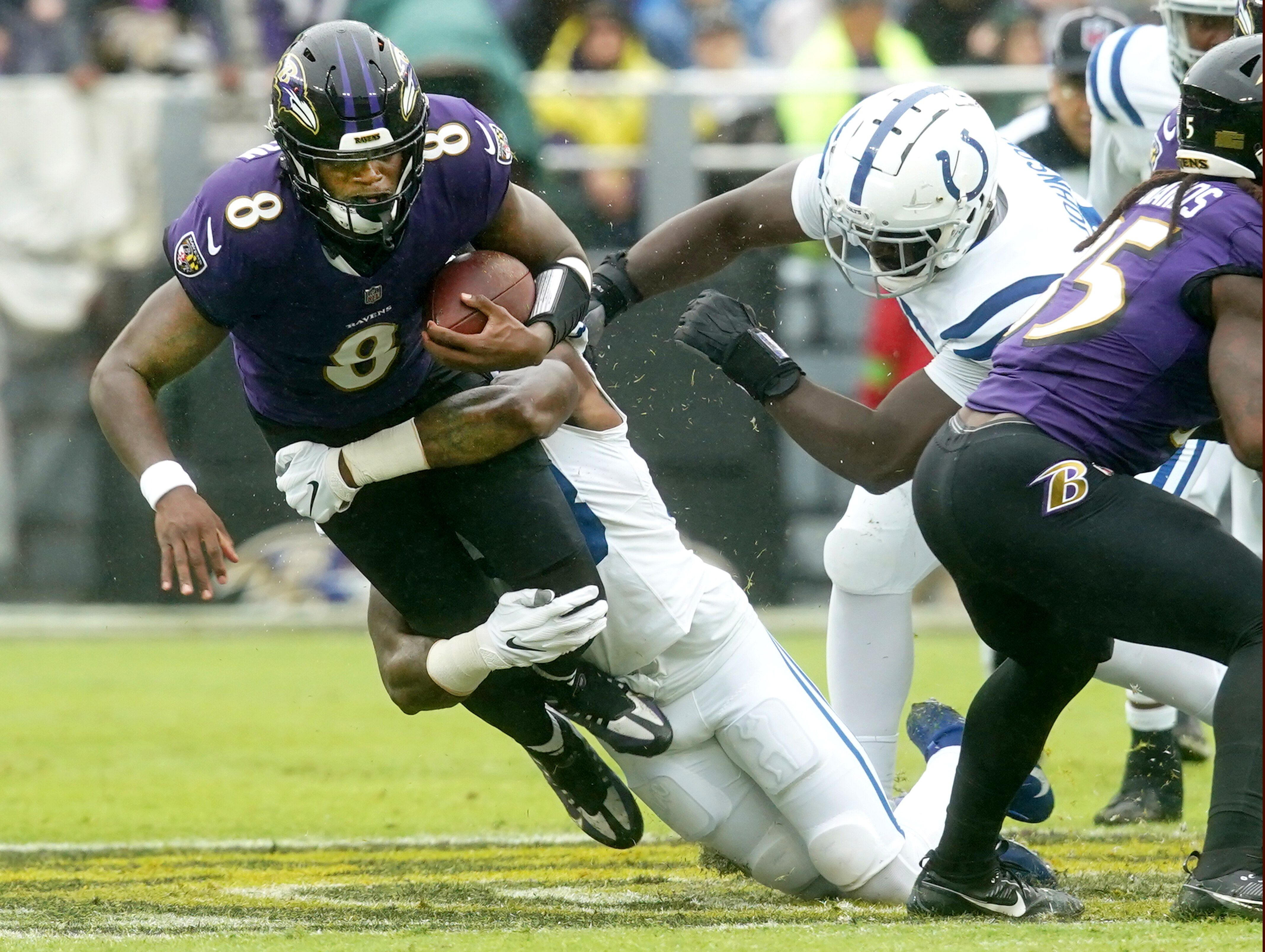 Colts defenders tackle Ravens quarterback Lamar Jackson during Sunday's game at M&T Bank Stadium.
