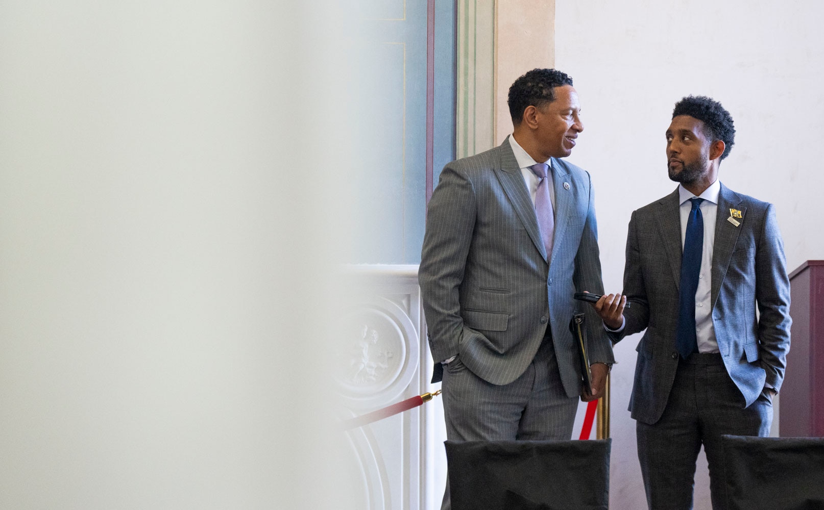 Baltimore City State's Attorney Ivan Bates and Mayor Brandon Scott chat on October 17, 2024 before sitting on a panel discussion about gun violence at the historic Clifton Mansion.