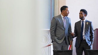 Baltimore City State's Attorney Ivan Bates and Mayor Brandon Scott chat on October 17, 2024 before sitting on a panel discussion about gun violence at the historic Clifton Mansion.