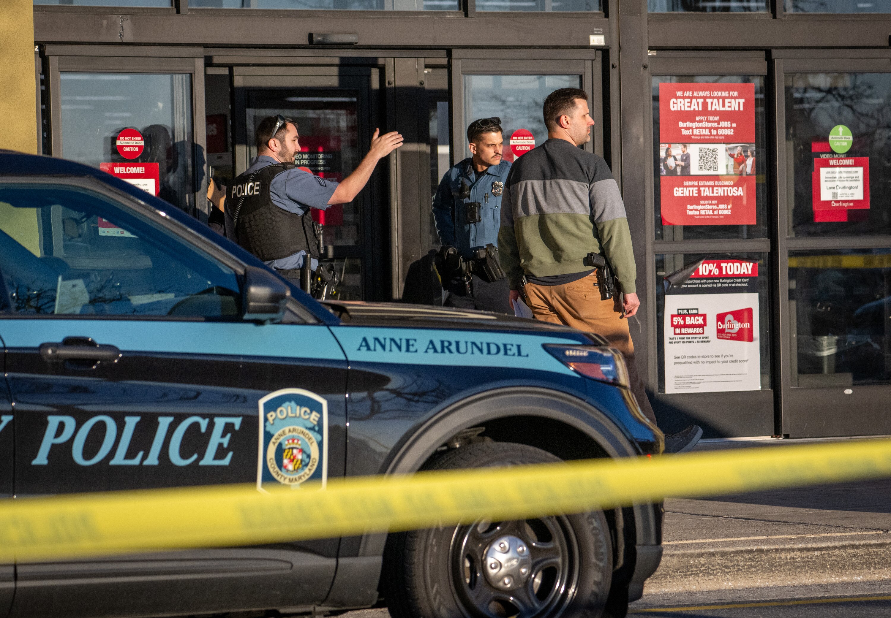 Police stand in the doorway to Burlington Coat Factory after an altercation occurred inside Arundel Mills Mall on Saturday in the vestibule area near Burlington Coat Factory led to a gun being fired, officials said.