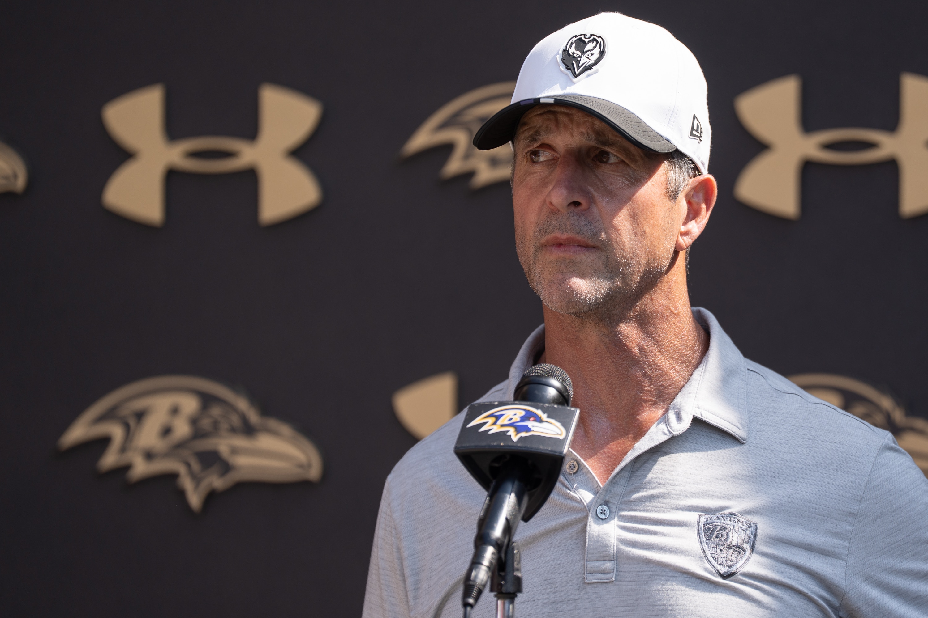 Ravens coach John Harbaugh answers questions after the team’s practice on July 24.