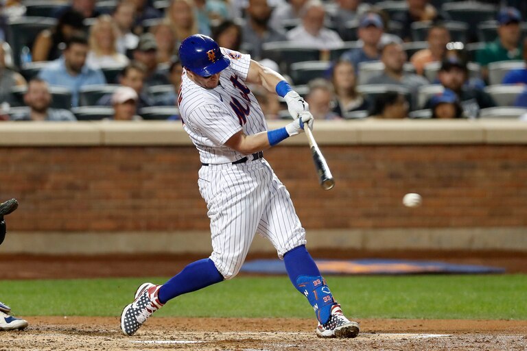 NEW YORK, NEW YORK - SEPTEMBER 12: James McCann #33 of the New York Mets connects on a fourth inning RBI base hit against the Chicago Cubs at Citi Field on September 12, 2022 in New York City.