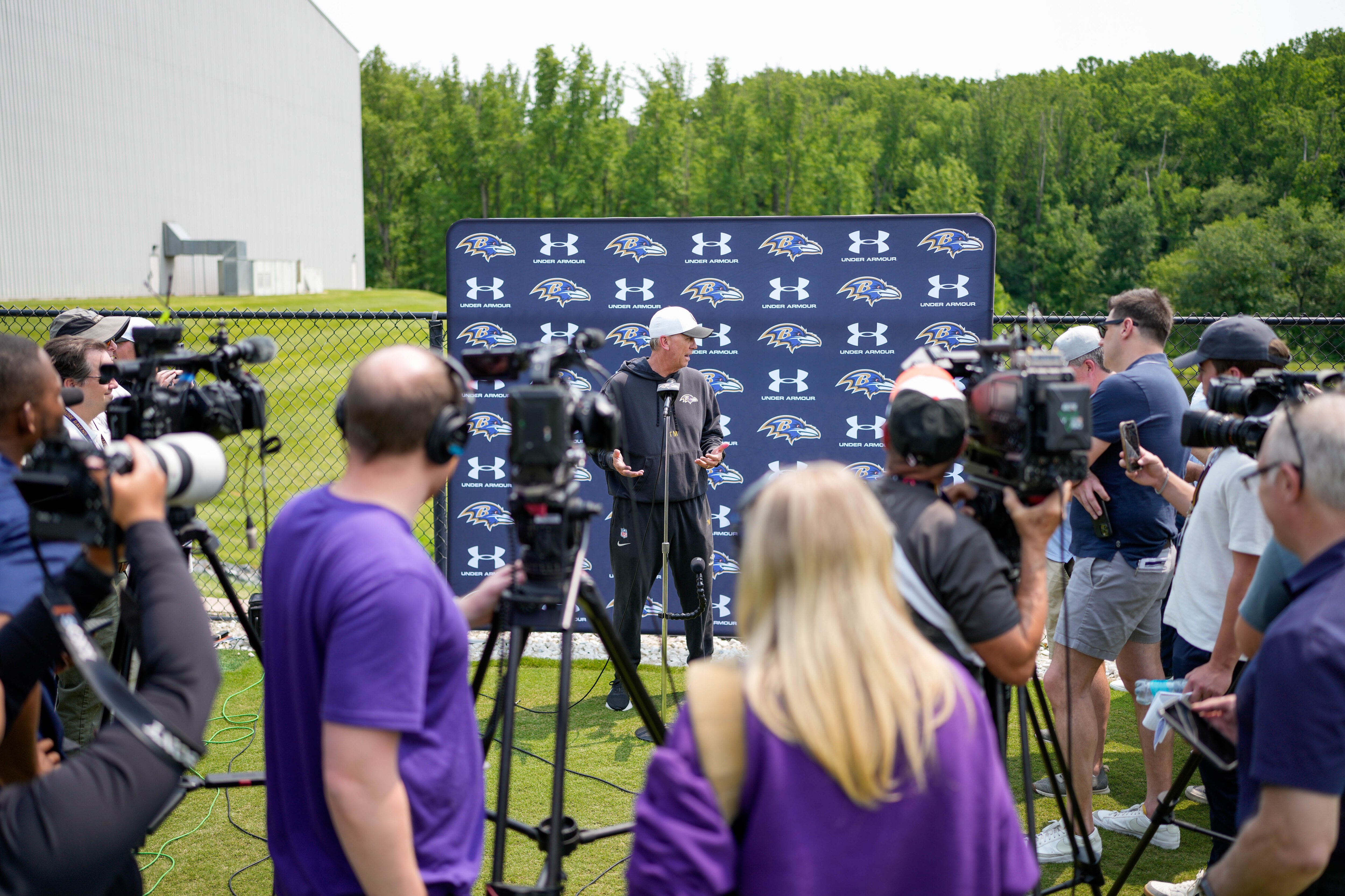 Offensive coordinator Todd Monken takes questions from reporters following the team’s organized team activities Tuesday.