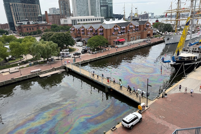 FRIDAY, JUNE 26, 2026 - Oil from one of the boats in the harbor leaks into the water causing a glistening rainbow colored trail.