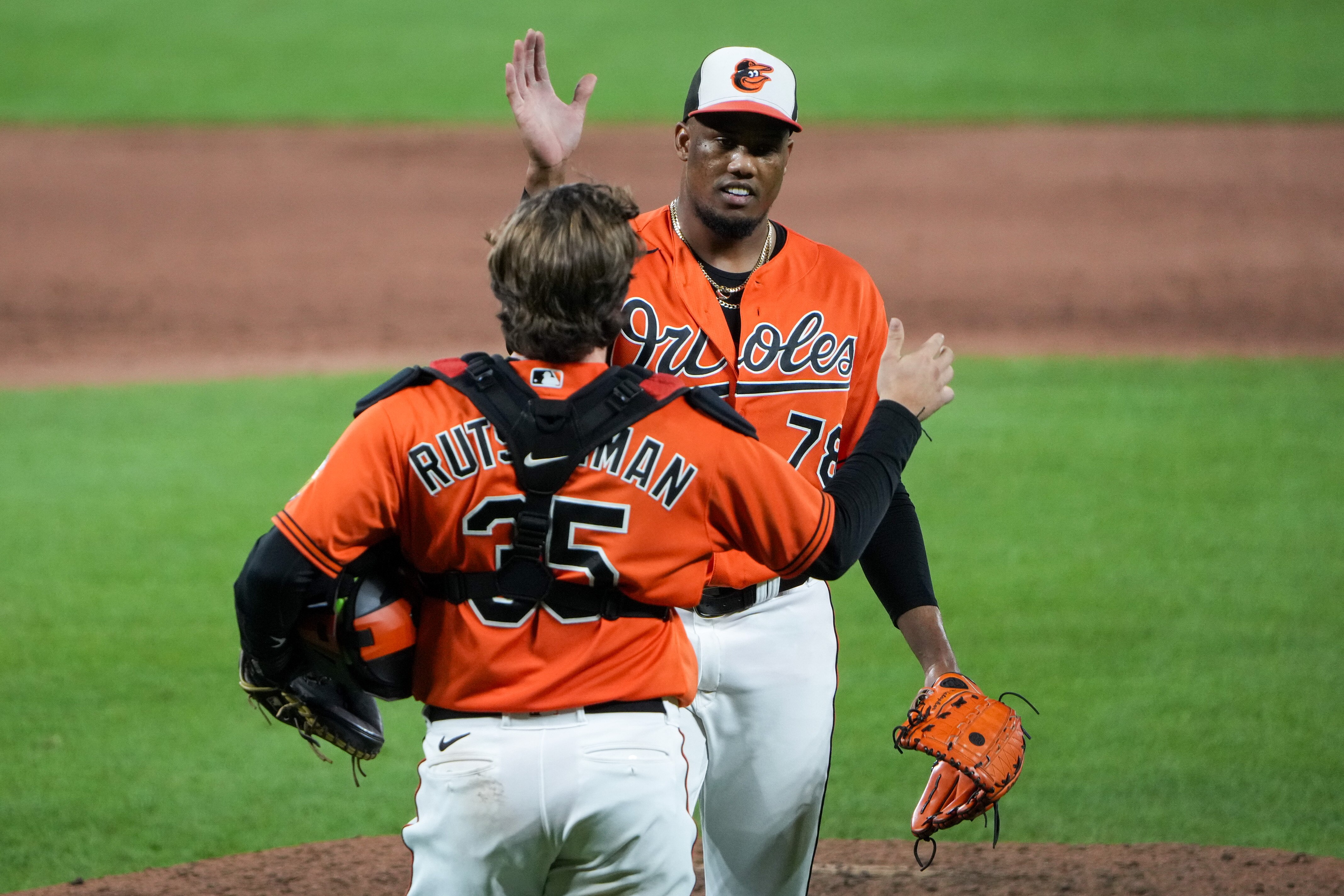 Baltimore Orioles relief pitcher Yennier Cano (78) celebrates with catcher Adley Rutschman (35) after pitching a perfect ninth inning and securing the win in a baseball game against the Colorado Rockies at Camden Yards on Saturday, August 26.