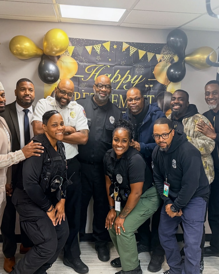 Master Corporal John Nicholson, center in black, at his retirement party. Nicholson died after his truck veered off the highway and crashed into a pole on Dec. 31, the same day he retired as a correctional officer with Prince George's County Department of Corrections.