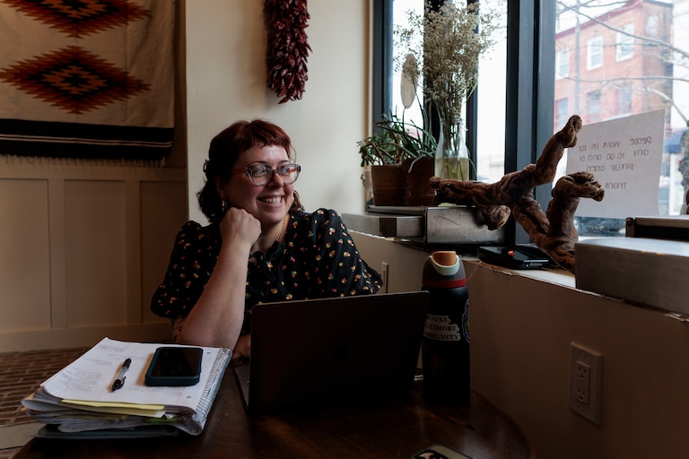 Samantha Claassen, owner of Golden West Cafe in Hampden, watches one of her employees deliver a takeout order across the street.