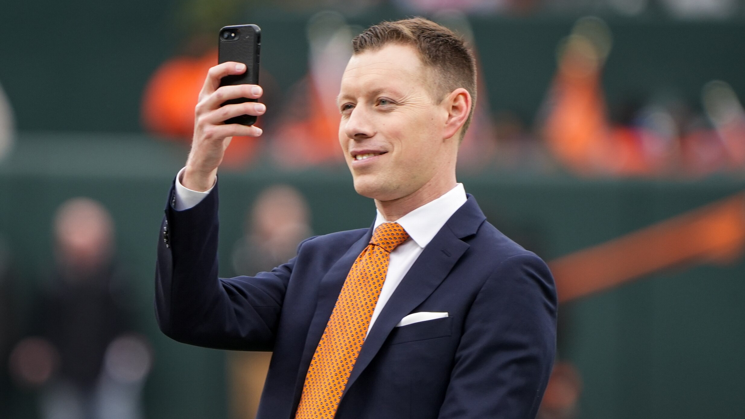 Orioles Broadcaster Kevin Brown takes a photo of the crowd from the field at Camden Yards on Thursday, March 28, 2024. The Baltimore Orioles won their first game of the season, 11-3, against the Angels.