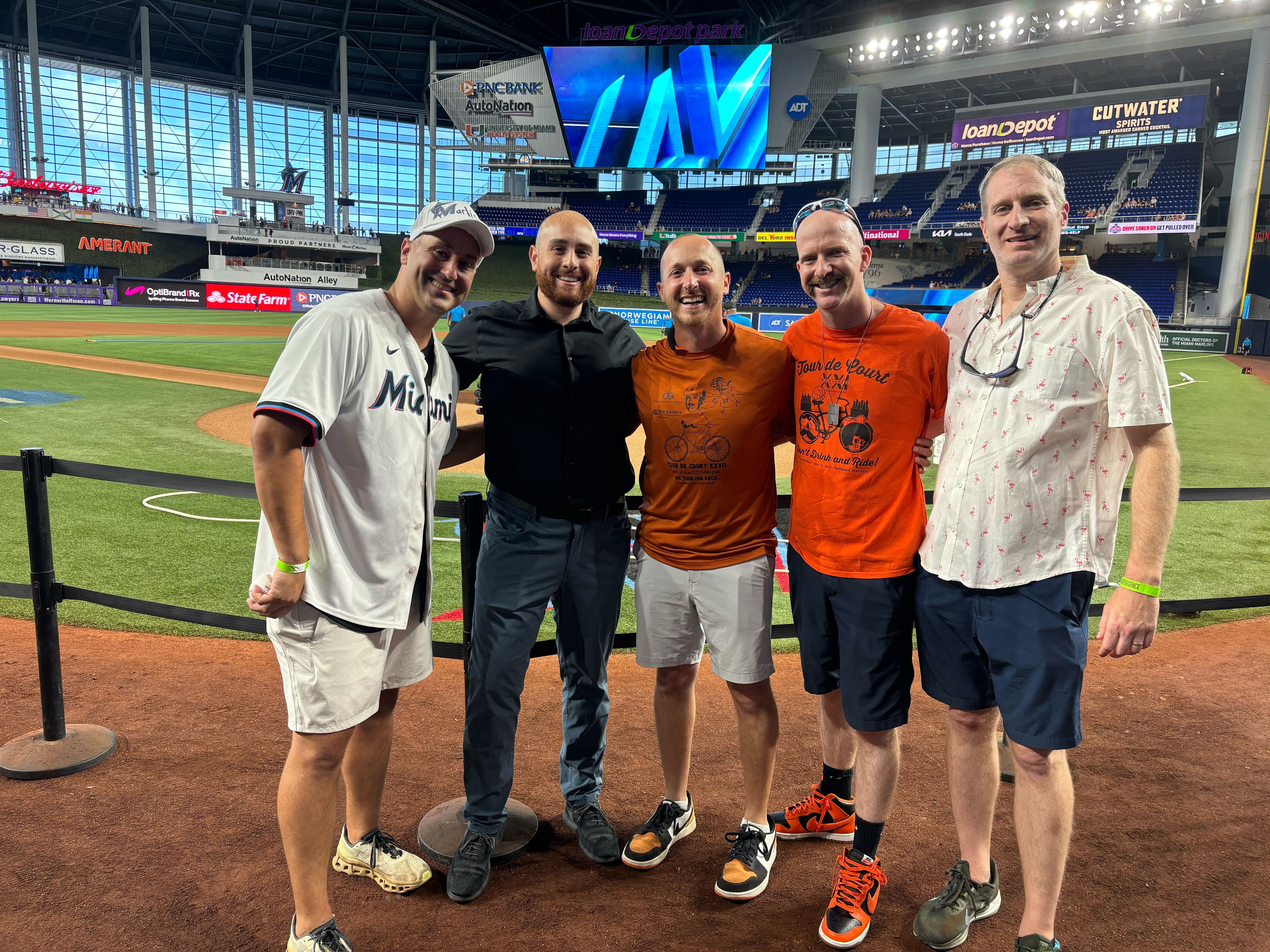 Tour de Court organizers Jon Minkove (right), Joe Rombro (second from right), Scott Zakheim (center) and Dani Vanderwalde (left) attend the game between the Orioles and Marlins on Wednesday night in Miami. (Andy Kostka/The Baltimore Banner)