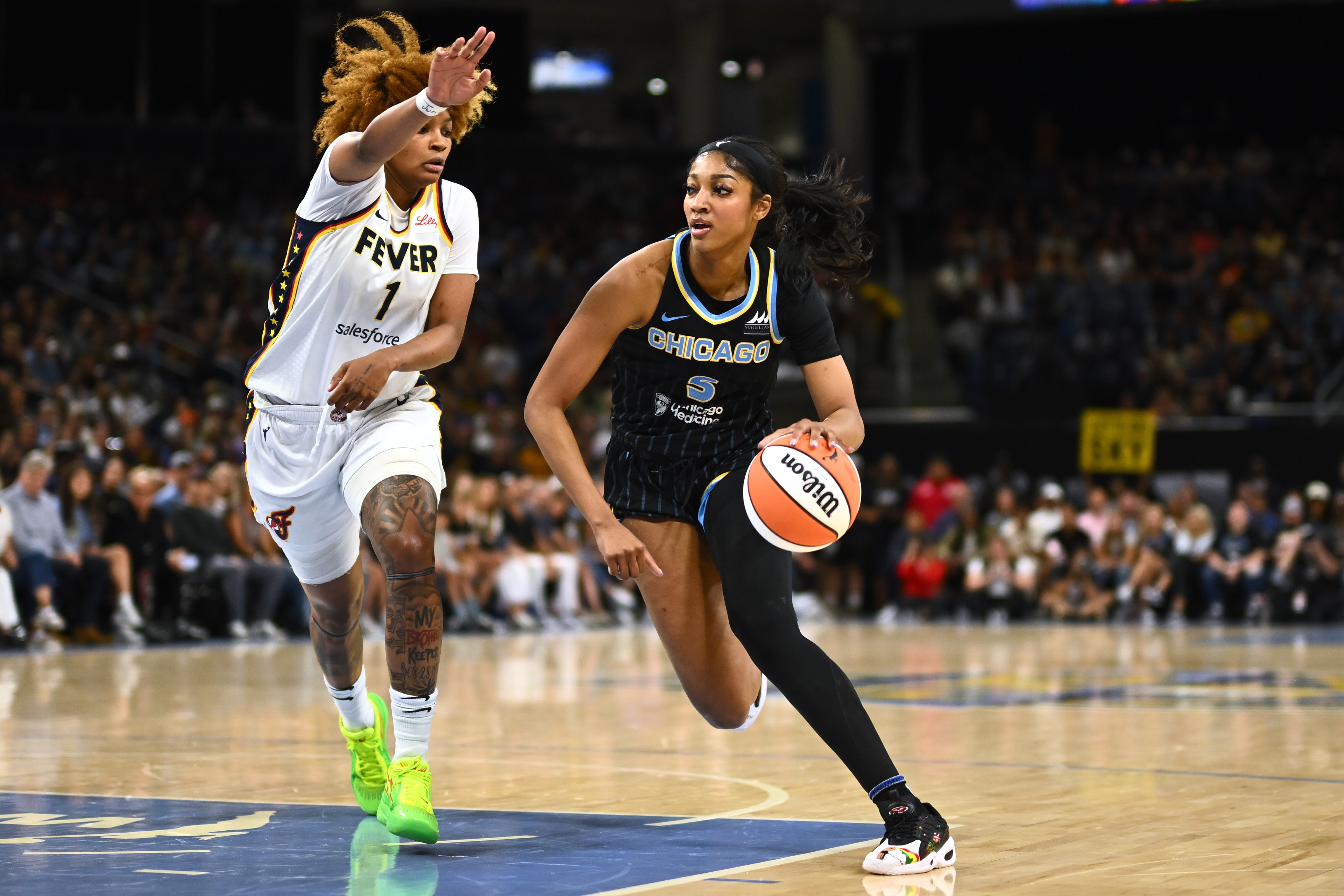 Angel Reese of the Chicago Sky drives to the basket against NaLyssa Smith of the Indiana Fever on Sunday in Chicago.