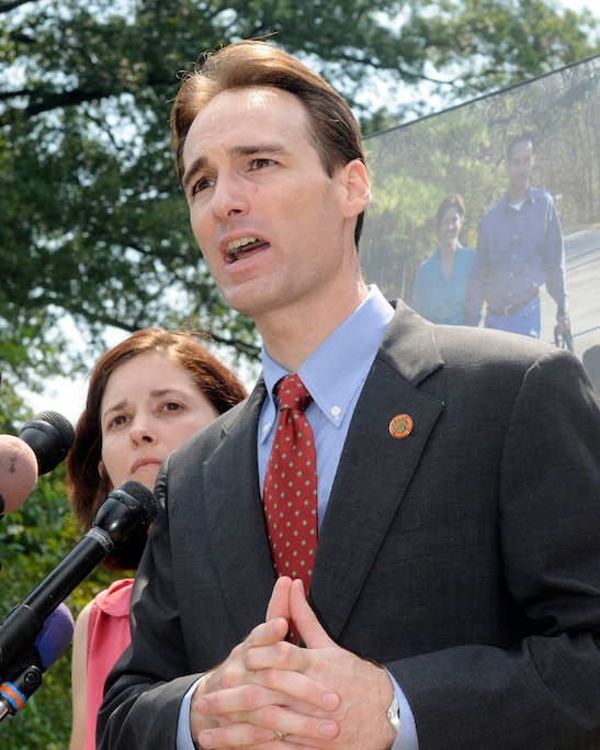 FILE - In this Aug. 7, 2008 file photo, Berwyn Heights,, Md., Mayor Cheye Calvo accompanied by his wife Trinity Tomsic speaks at a news conference at their house in Berwyn Heights, Md. (AP Photo/Stephen J. Boitano, File)