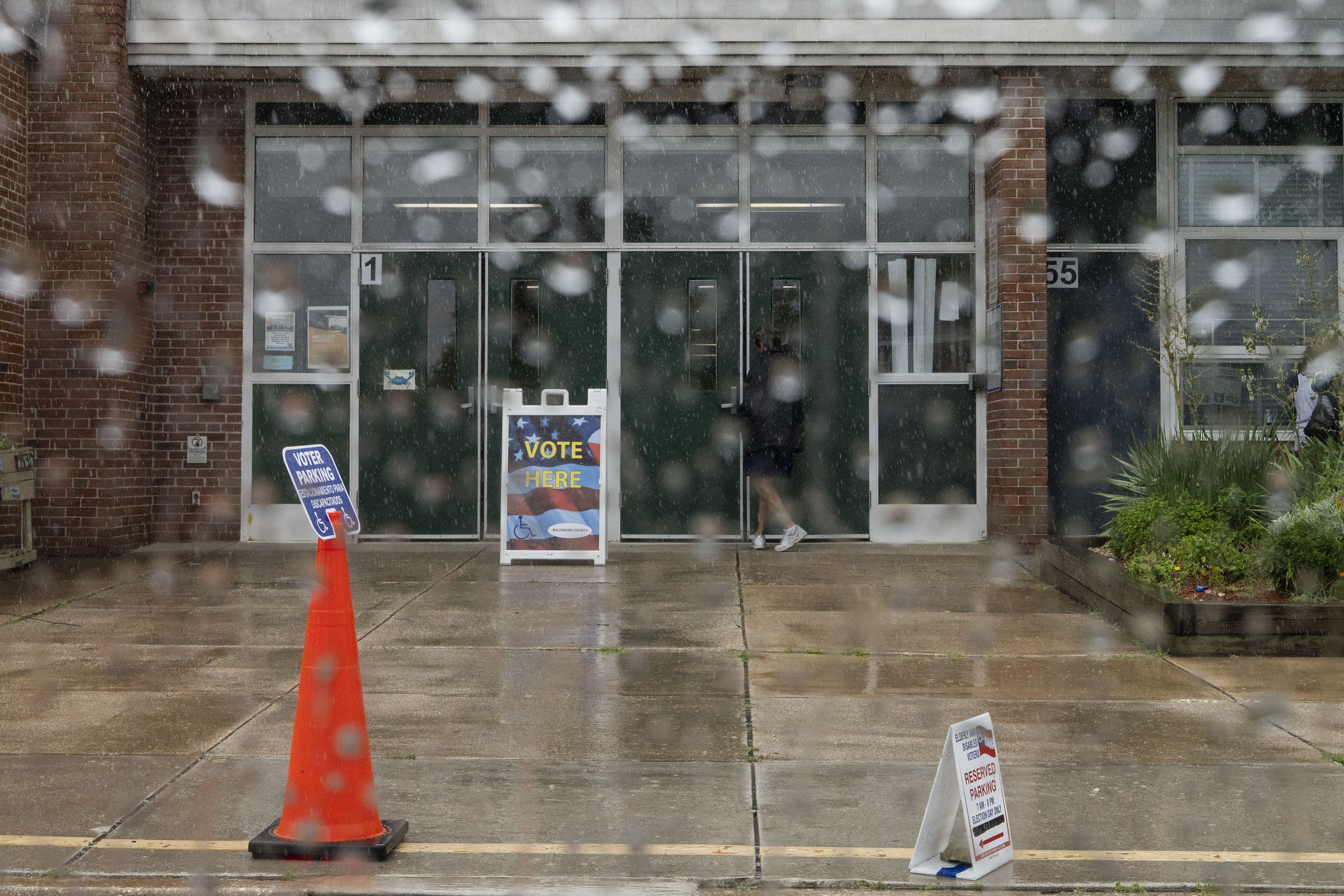 Many voters arrived at the polls wet on a rainy primary day. 