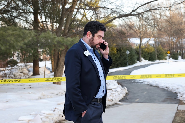 Rockville City Council member Adam Van Grack on the phone outside of Thomas S. Wootton High School after a reported shooting at the school on Monday. Van Grack has a sophomore at the school.