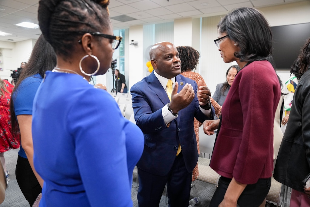 Incoming City Schools CEO Dr. Jermaine Dawson, center, speaks with attendees following a Baltimore City Board of School Commissioners meeting at the Baltimore City Public Schools headquarters in Baltimore, Md. on Monday, April 20, 2026.