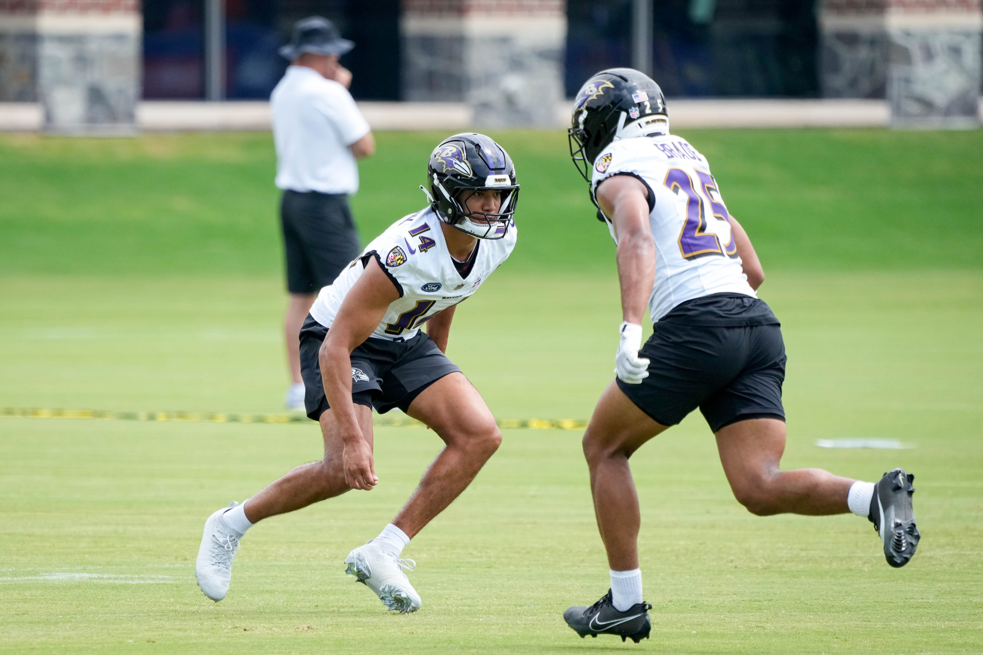Safety Kyle Hamilton (14) and cornerback Chidobe Awuzie (25) run a drill together during practice on July 24.