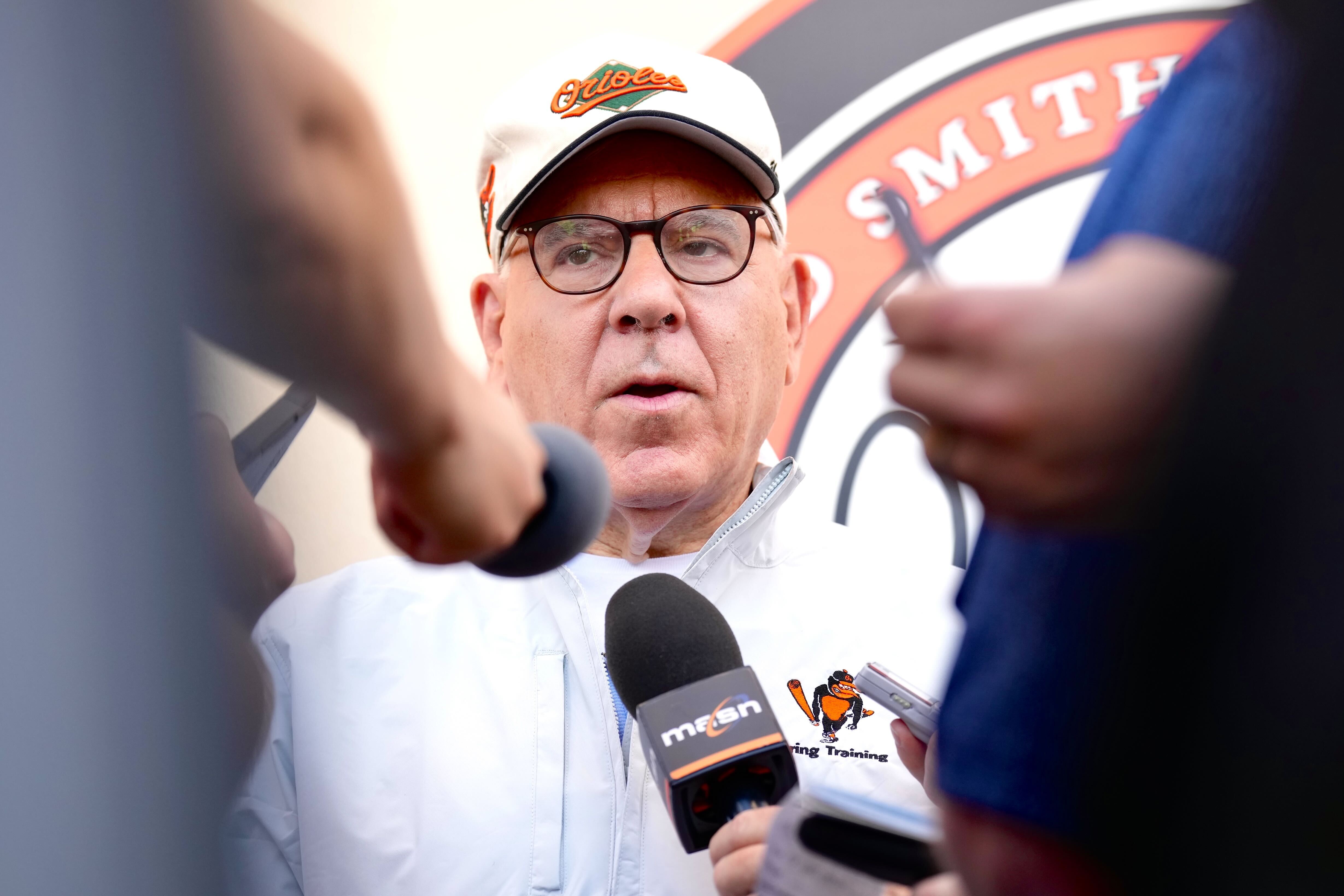 Orioles owner David Rubenstein takes questions from reporters outside the team’s clubhouse at Ed Smith Stadium.
