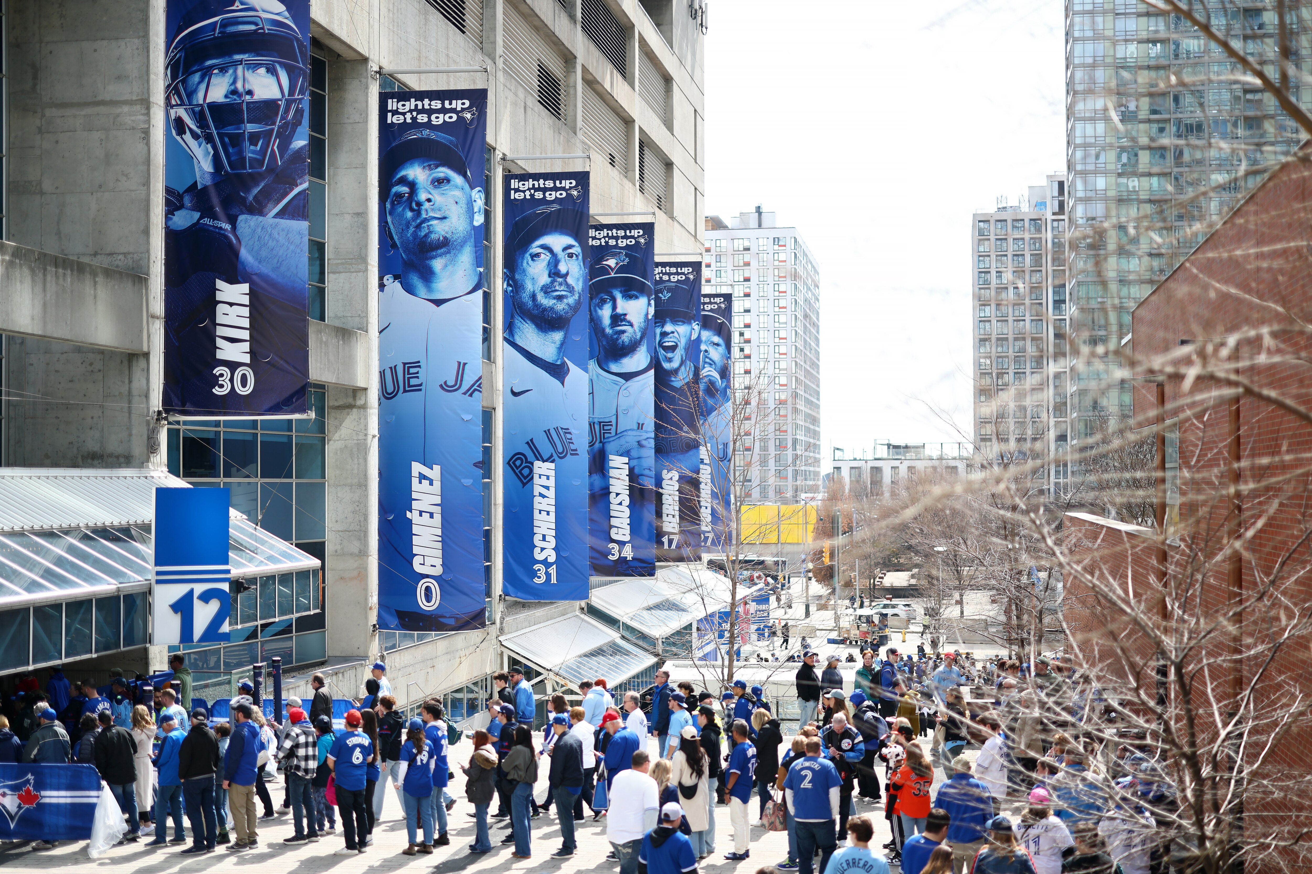 TORONTO, ONTARIO - MARCH 27: Fans arrive outside Rogers Centre before the Opening Day game between the Toronto Blue Jays and the Baltimore Orioles on March 27, 2025 in Toronto, Ontario.