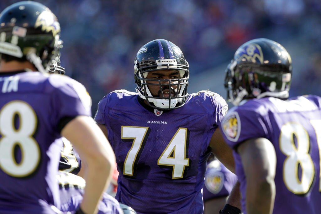 Michael Oher, No. 74 of the Baltimore Ravens, waits in the huddle against the Arizona Cardinals at M&T Bank Stadium on Oct. 30, 2011 in Baltimore, Maryland. The Baltimore won 30-27.  (Photo by Rob Carr/Getty Images)