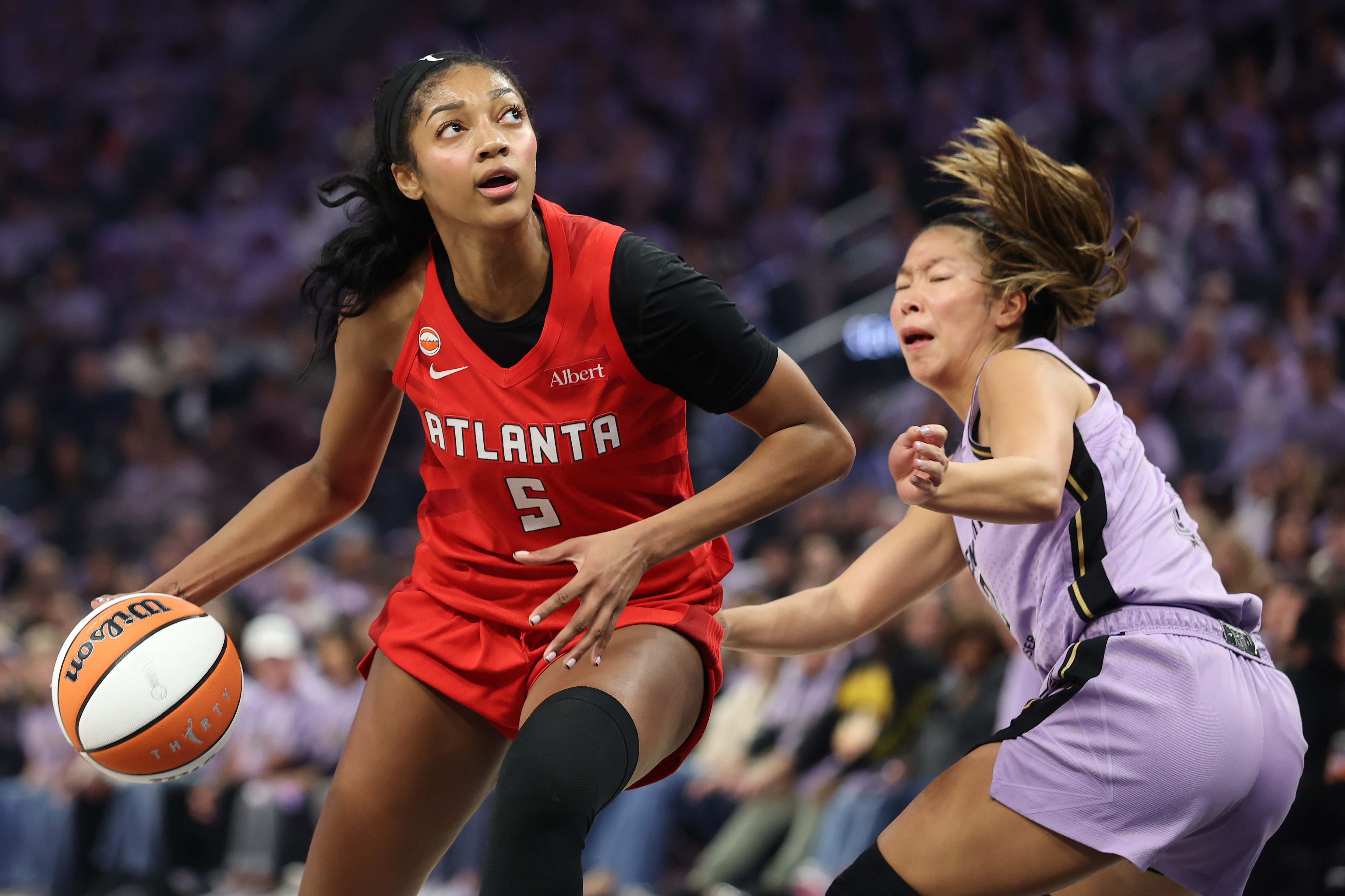 Baltimore native Angel Reese of the Atlanta Dream dribbles against Kaitlyn Chen of the Golden State Valkyries during the second quarter in game two of the WNBA Finals.