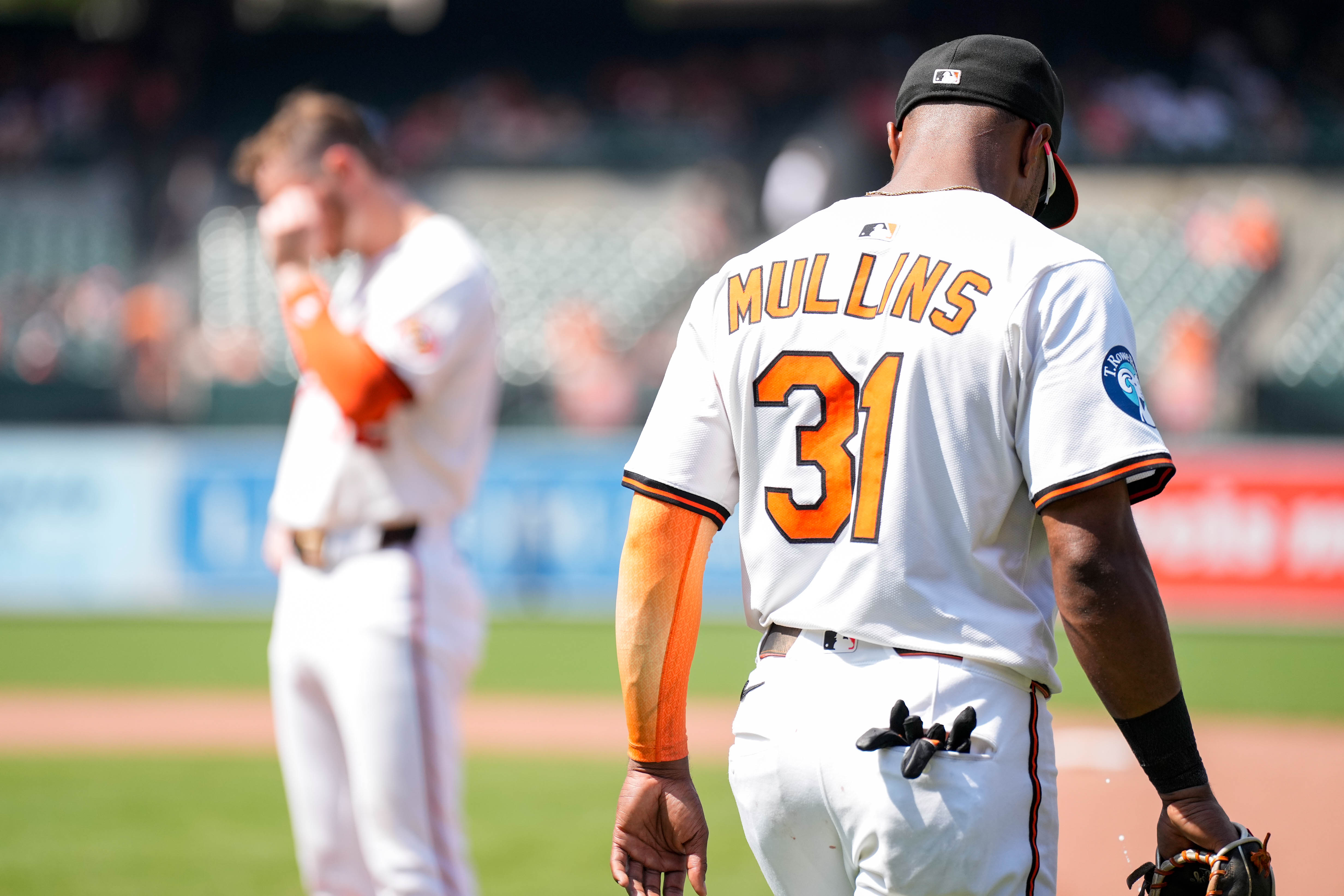 Center fielder Cedric Mullins and first baseman Ryan O'Hearn cross paths Wednesday during the eighth inning of their final game with the Orioles.