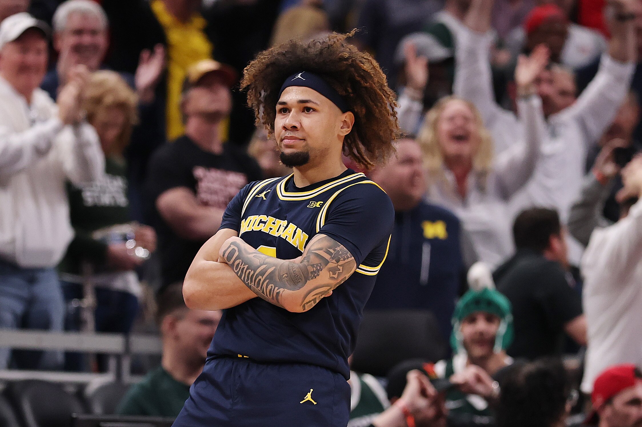 Michigan fans cheer Tre Donaldson after he made the layup that beat Maryland 81-80 Saturday in the Big Ten semifinals in Indianapolis.