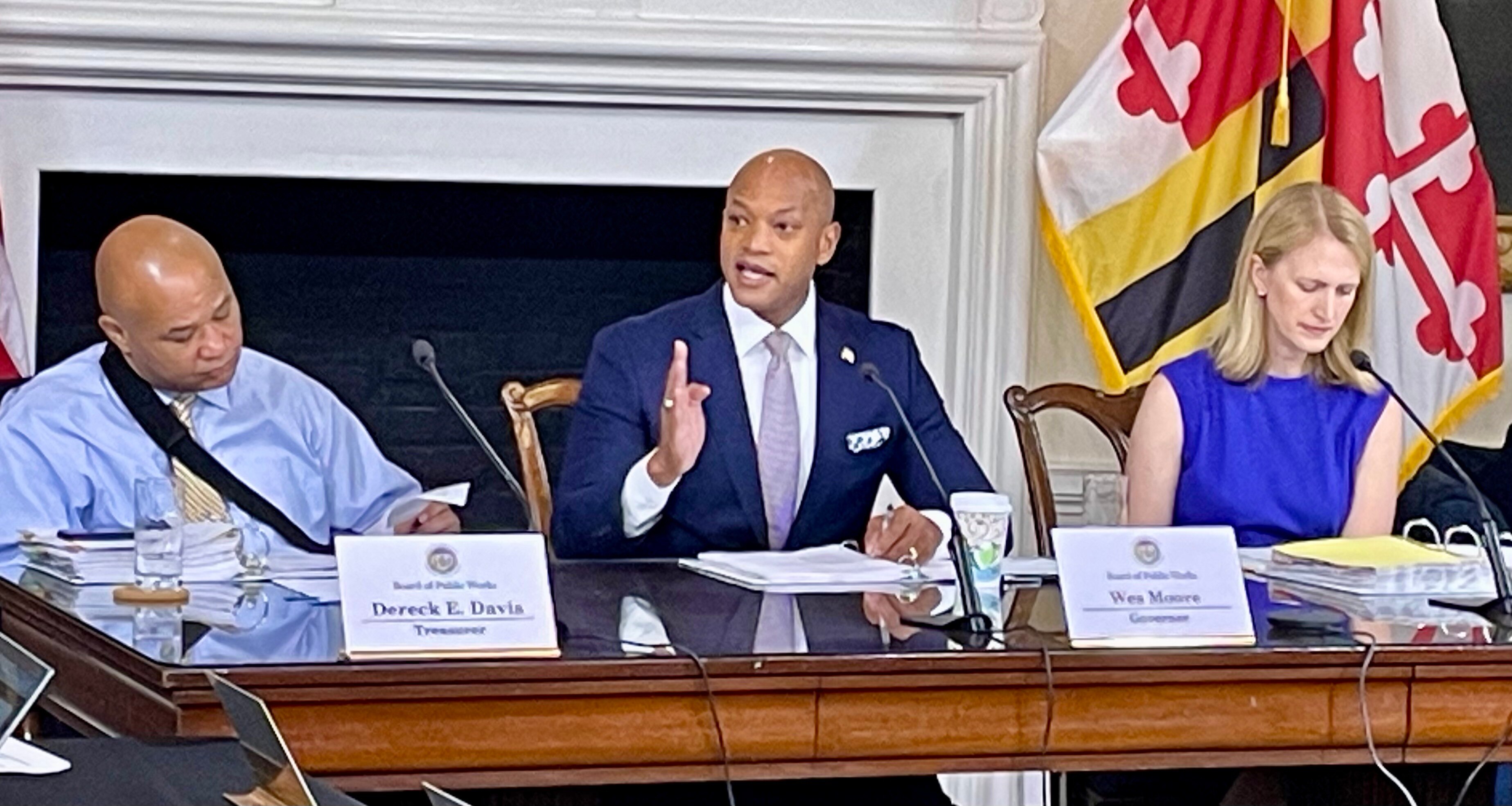 Maryland Gov. Wes Moore, center, speaks about budget cuts at a meeting of the Maryland Board of Public Works at the State House in Annapolis on Wednesday, July 17, 2024. He's joined by Treasurer Dereck Davis, left, and Comptroller Brooke Lierman, right.