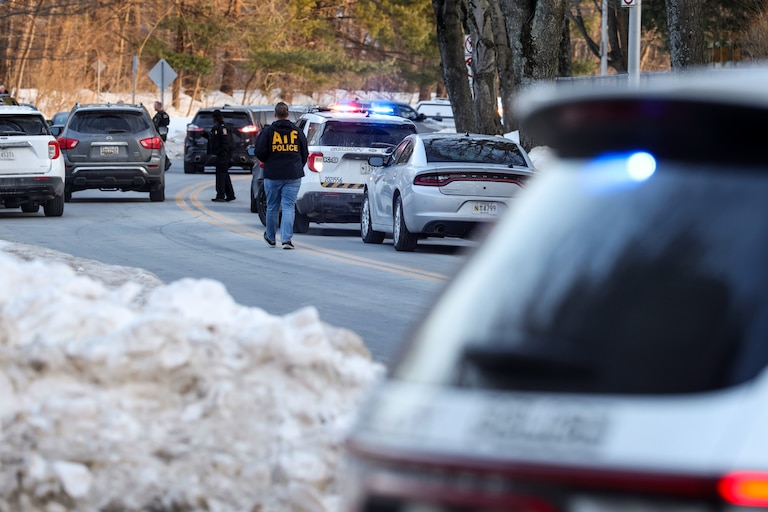 An ATF agent walks past a police barricade near Thomas S. Wootton High School after a reported shooting at the school on Monday.