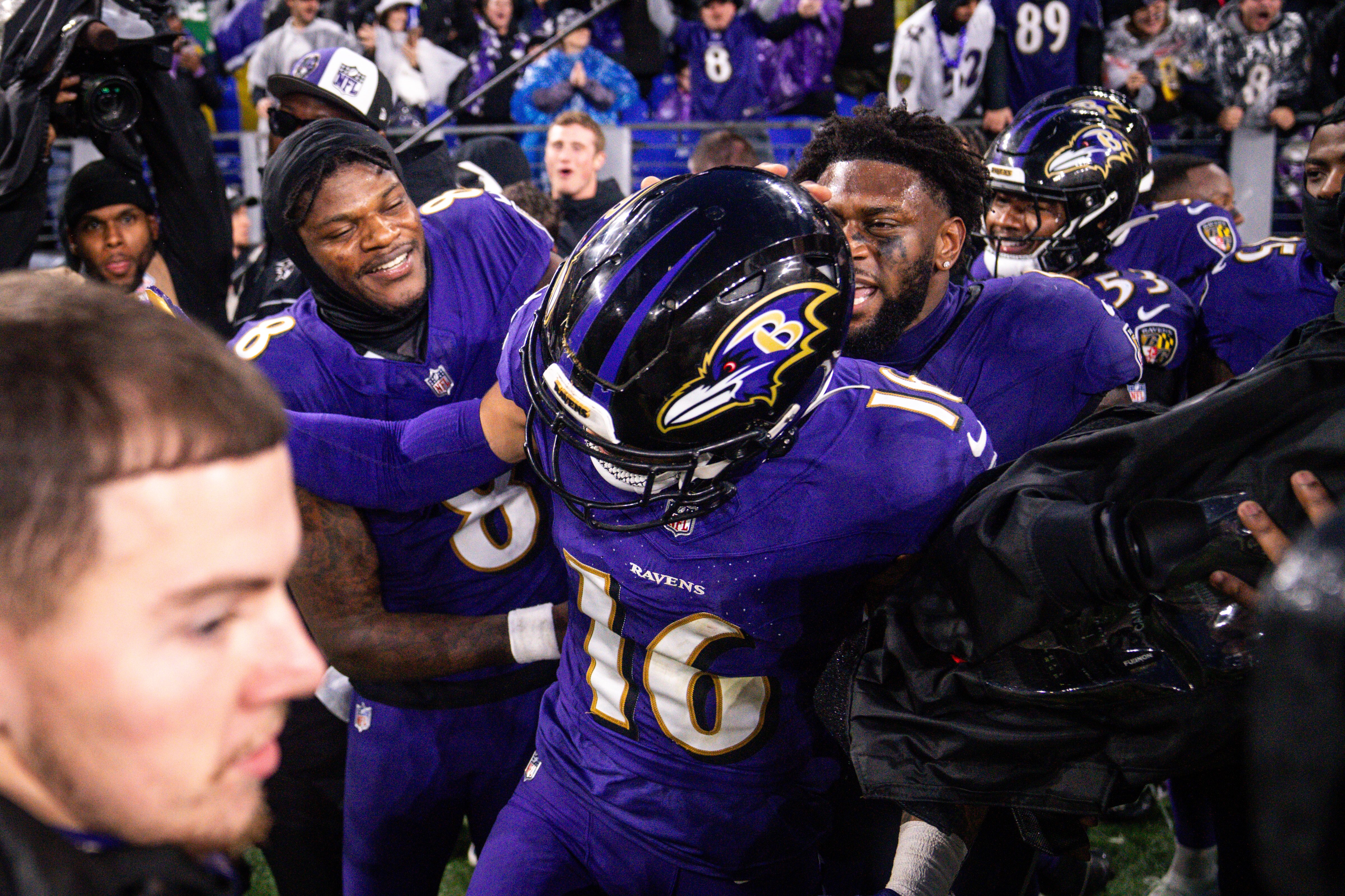 Ravens quarterback Lamar Jackson (8) cheers on wide receiver Tylan Wallace after Wallace scored the game-winning touchdown in overtime against the Los Angeles Rams on Sunday.