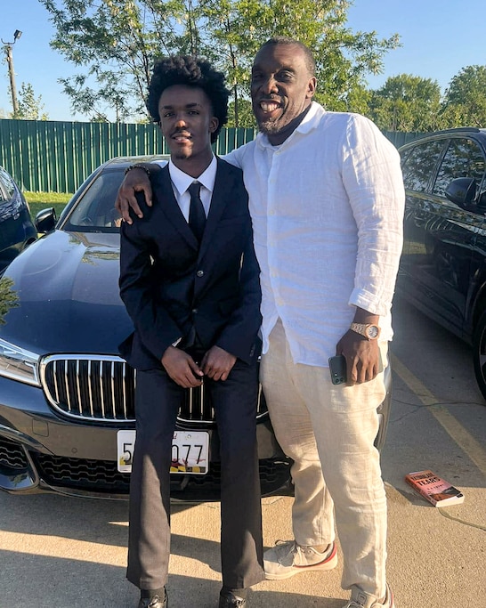 Rising senior Acem Ajahni, left, with his father, Acem Hall, at Ajahni's national honor society induction ceremony.