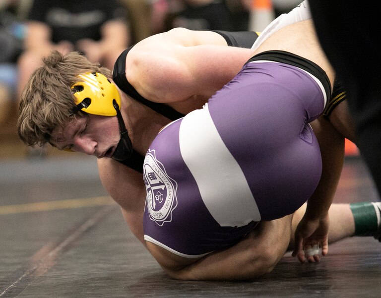 South Carroll's 170-pound senior Class 2A-1A state runner-up Rylan Moose (top) used a cradle pinning maneuver en route to a come-from-behind, 5-4 victory over top-ranked Mount St. Joseph sophomore Nicolas Barnabae.