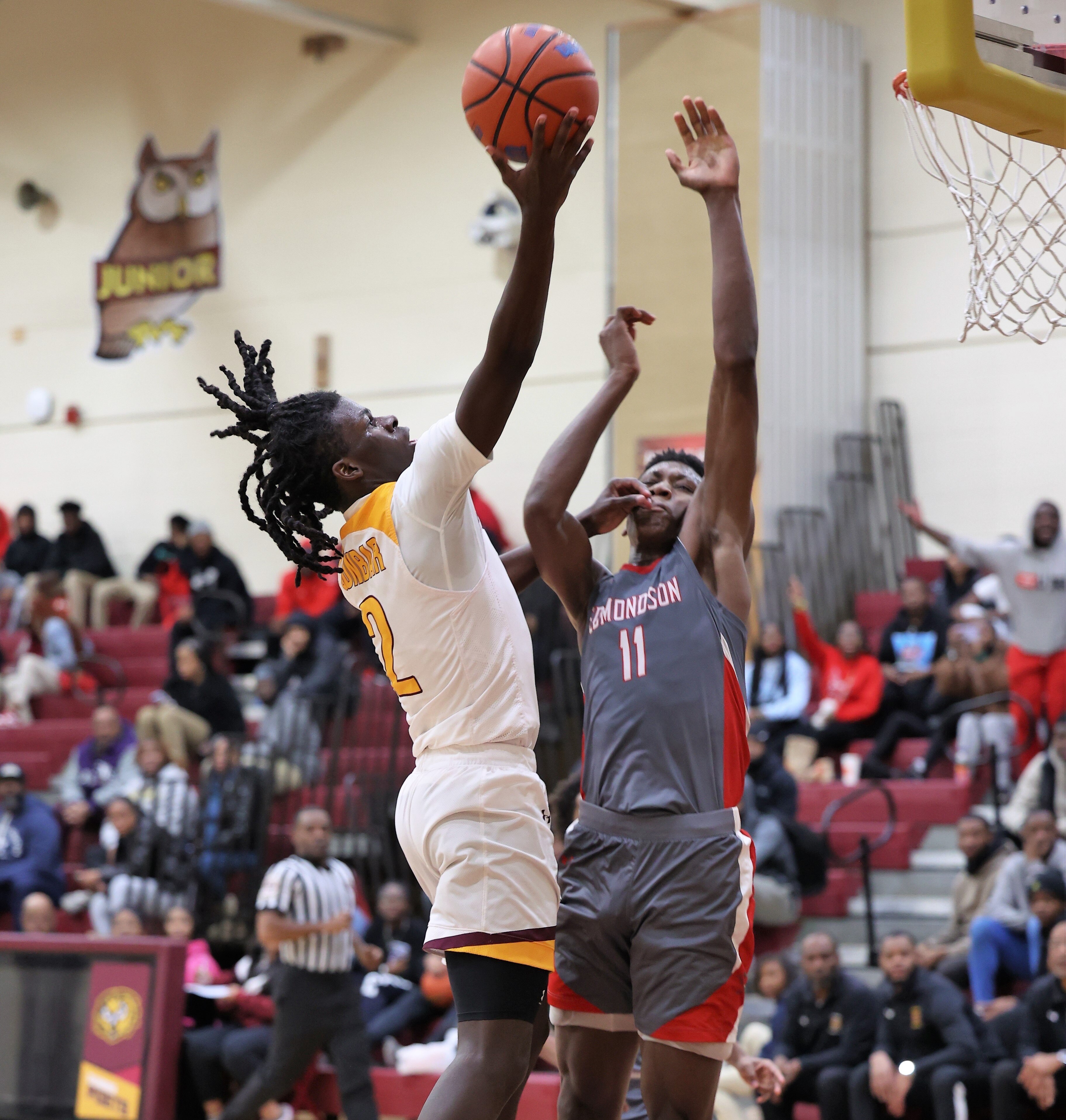 Dunbar's Otis Toney heads up to the basket as Edmondson's Marcus Jackson defends during Thursday's Baltimore City boys basketball contest. Toney finished with 24 points as the Poets built an early lead and held on for a 69-60 win over No. 6 Edmondson in East Baltimore.