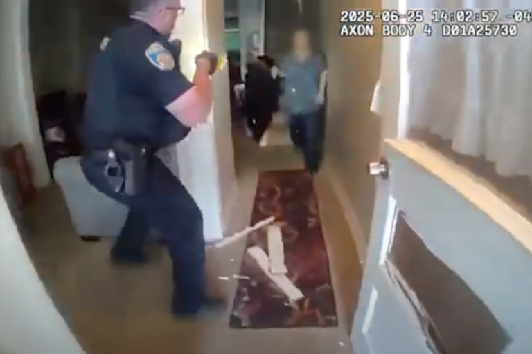 A still image from body cam footage released on Wednesday, July 9, 2025 by the Baltimore Police Department, shows police after breaking down the front door and entering the home of 70-year-old Pytorcarcha Brooks.
